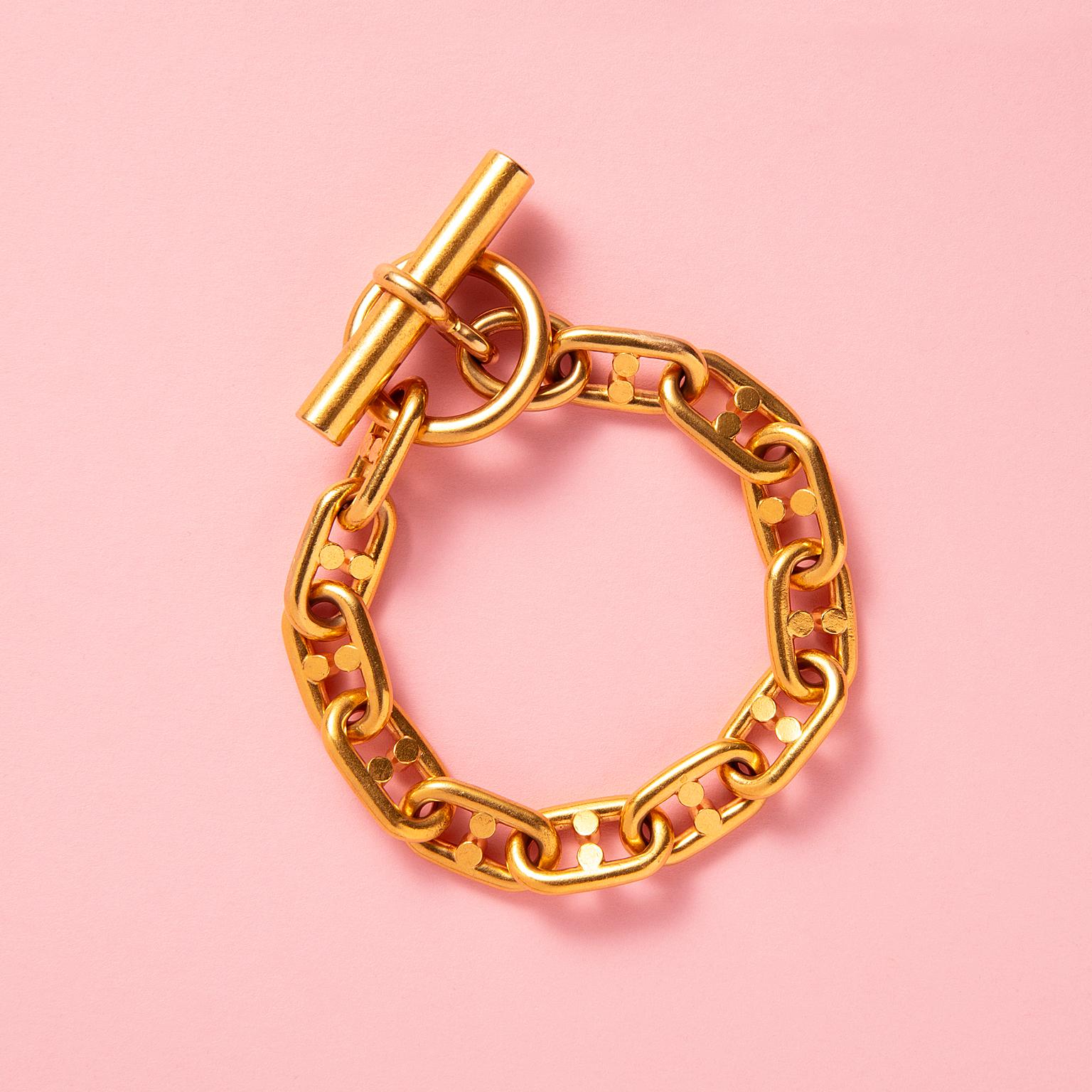 An 18 carat yellow gold bracelet with a variant to the 'chaîne d'Ancre' link consisting of 12 links of polished wire each with two wires countered to the link with toggle clasp, with French eagle mark and French master mark for Rollang & Cie, circa