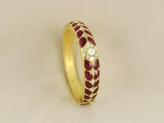 An 18K gold Indian ruby and natural diamond polki bangle