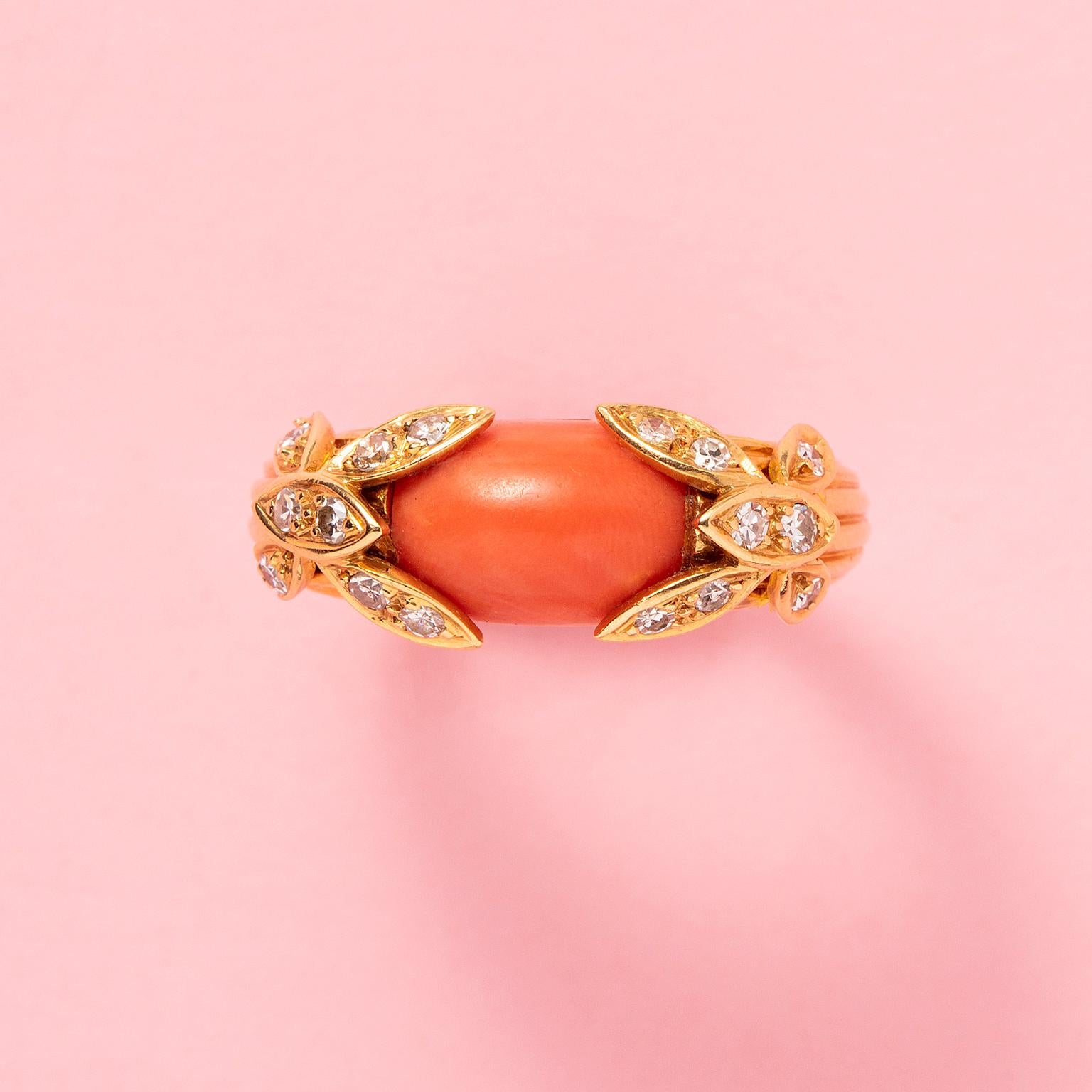 An 18 carat gold ring with a cabochon cut coral and flowers set with diamonds on each side, French circa 1970, with French assay marks and the French master mark for Jean & Pierre Bellin.

weight 8.2 g
ring size: 17 mm / 6 3/4 US
width: 2 - 9 mm