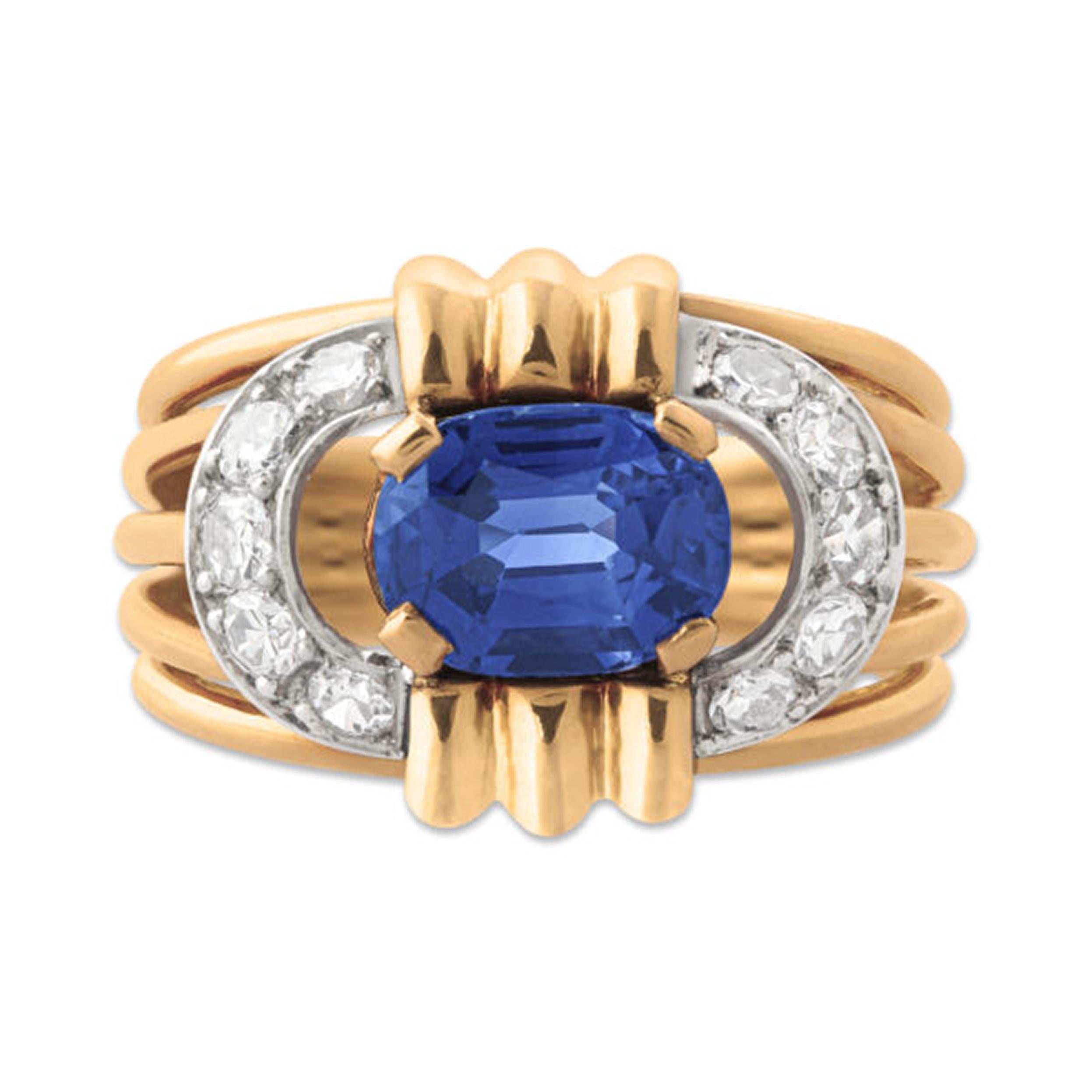 A gold, sapphire & diamond ring, set at the centre with a 1.77 carat oval-cut sapphire in a decorative openwork gold mount surrounded by 10 circle-cut diamonds. The sapphire is unheated and of Kashmir origin, it is accompanied by a Gubelin