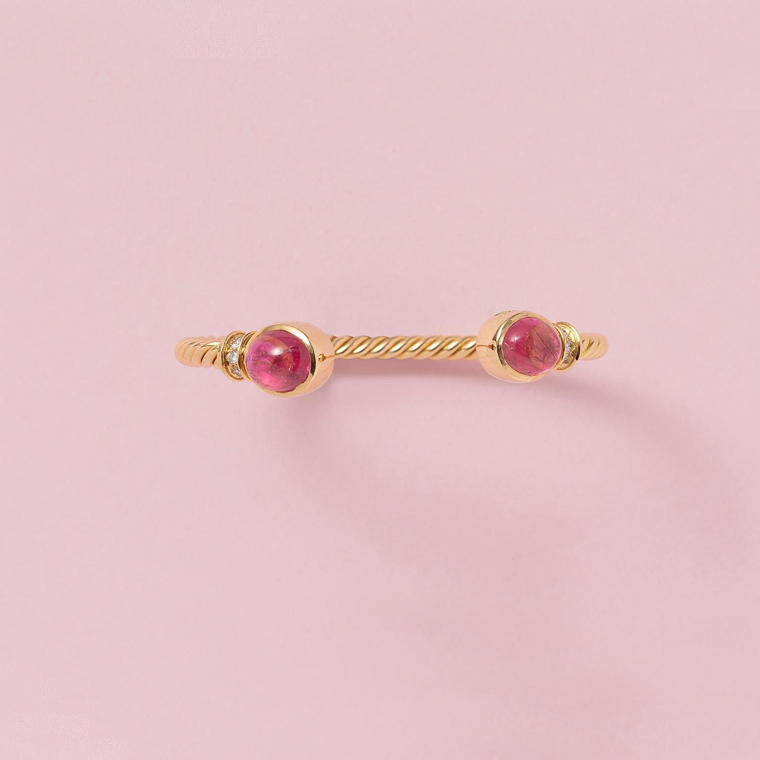 An 18-carat gold bracelet of a twisted gold wire with a cabochon cut bright pink tourmaline on each end (app. 2.9 crt each) and a rim of brilliant cut diamonds, signed: Bulgari, model Trombino with master mark *2337AL, Italy.

weight: 23.57 g
outer