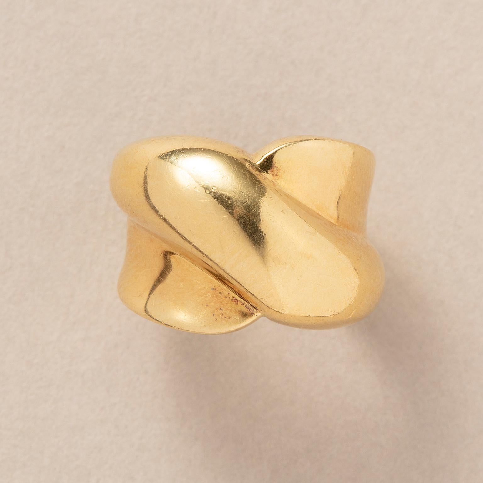 A wide 18 carat yellow gold ring with cross over bands.

weight: 12.3 g
size: 16.25 mm. / 5 3/4 US
width: 6 - 15 mm