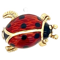 An 18k yellow gold and enamel brooch by Alessandro Rossi.