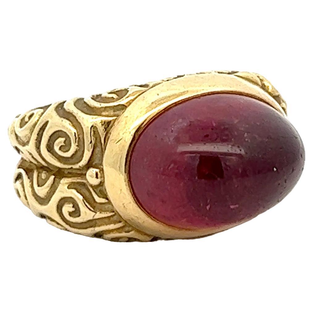 An 18k yellow gold and pink Tourmaline ring By Elizabeth Gage.