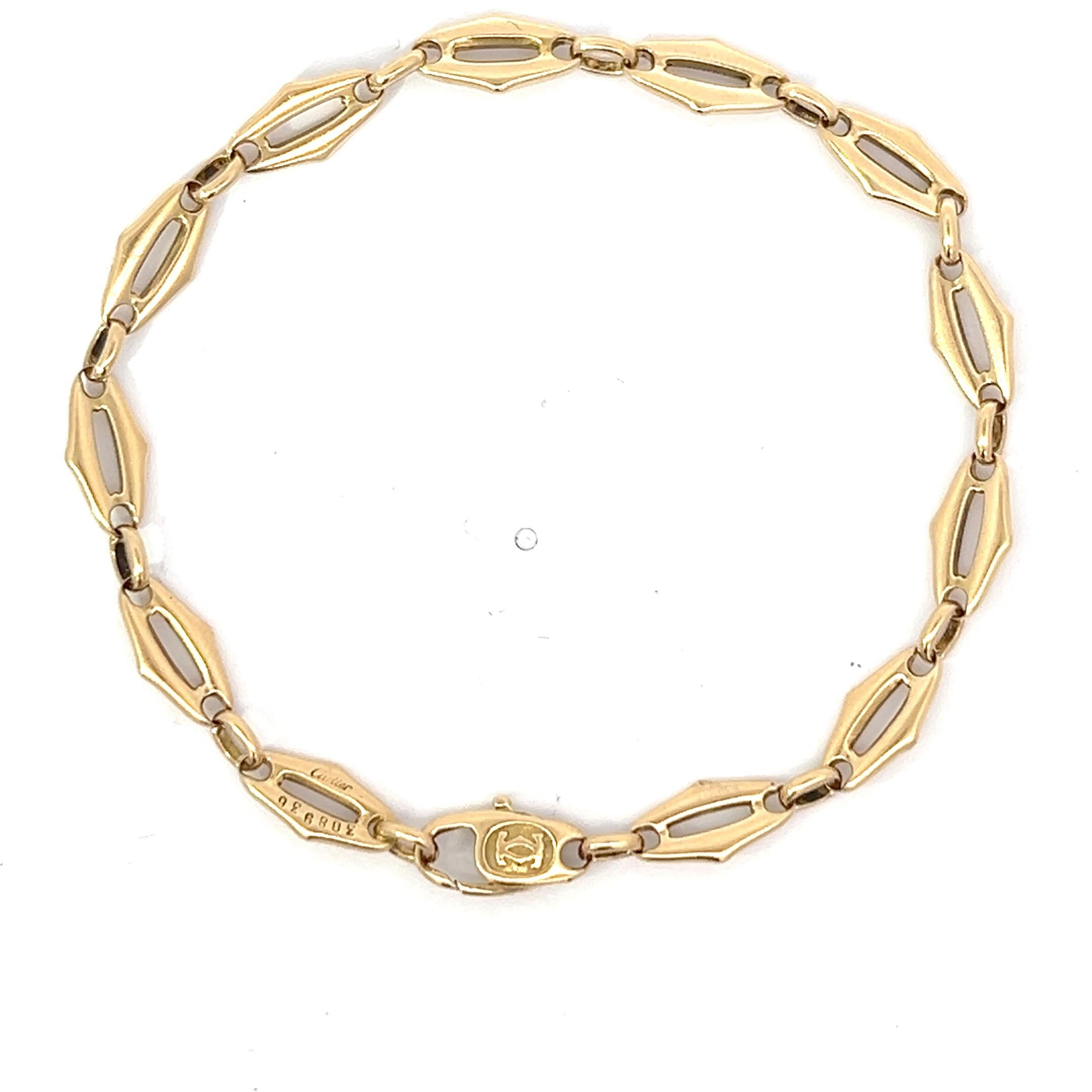 An 18k yellow gold bracelet by Cartier.

Origin: imported into France.
Age: circa 1990.
Measurements: Circa 19 cm long.
Weight: circa 10.5 grams.
Hallmarks: marked with French import marks for 18k gold.
Signed: Cartier.
Engraved with the number