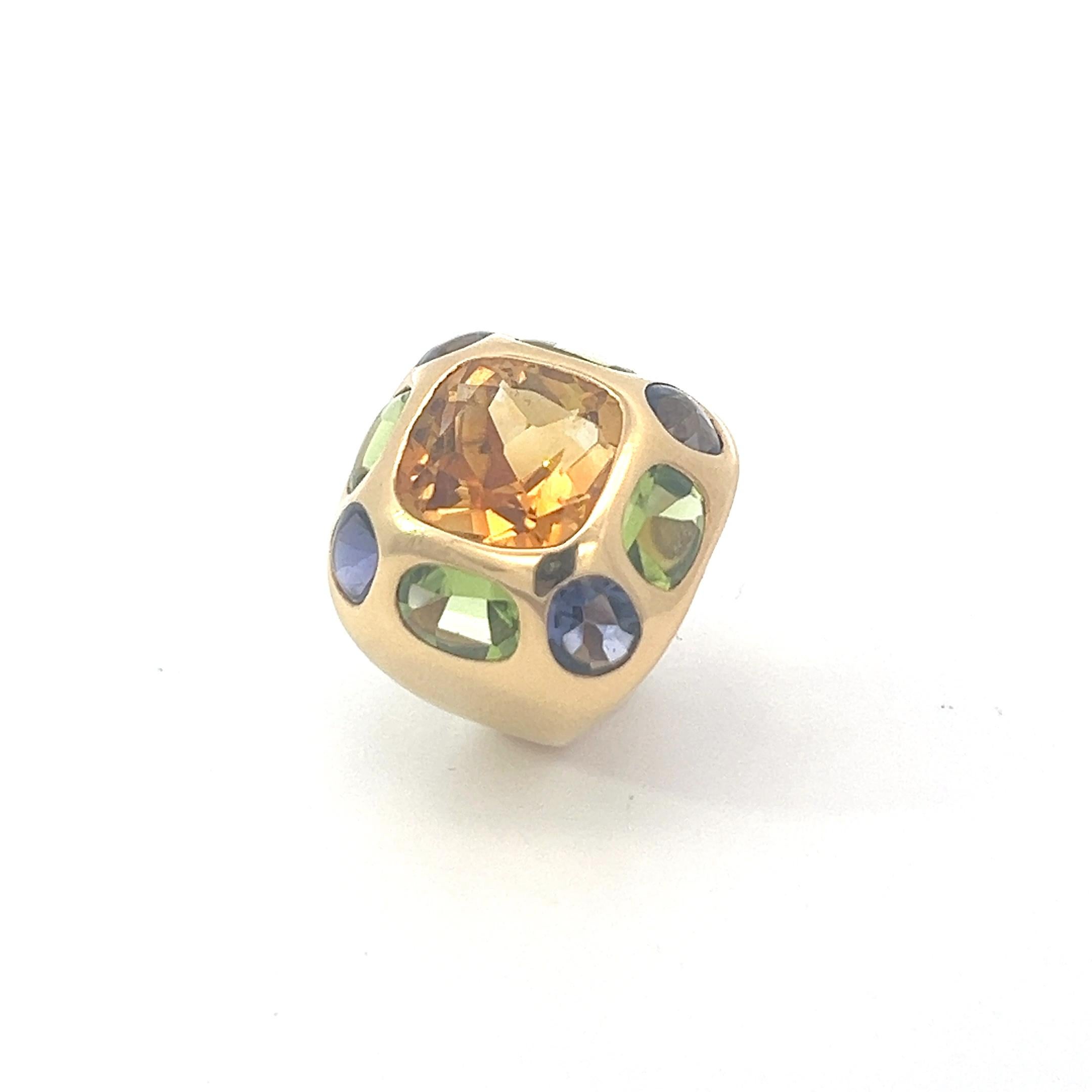 An 18k yellow gold, citrine, peridot and iolite ring by Chanel. 

Origin: France.
Age: end of 1980s,
Measurements: Size 49. Due to the markings on the inside of the band, this ring can't be resized.
Weight: circa 20.1 grams.
Hallmarks: Marked with