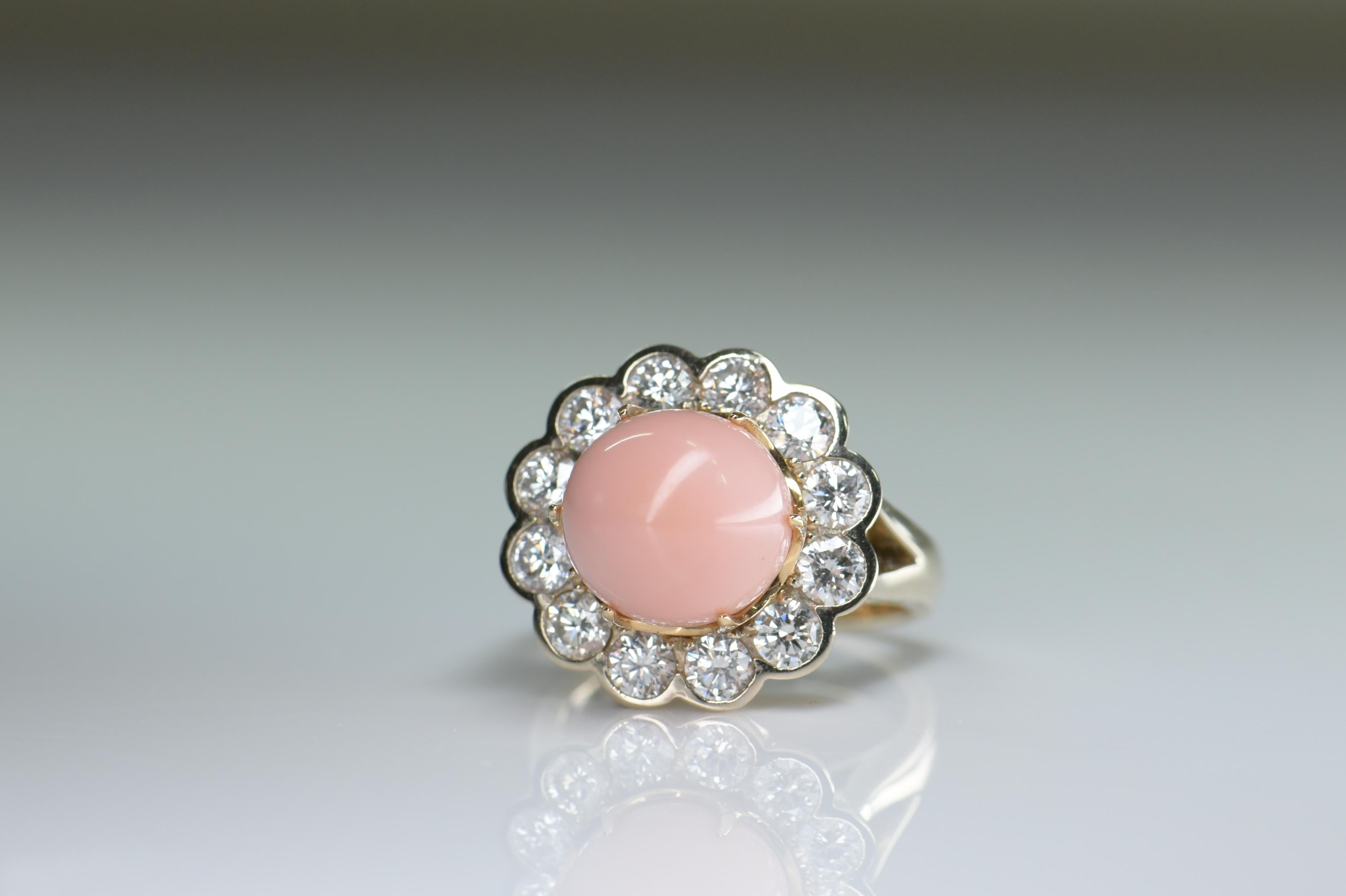 A gorgeous pink natural conch pearl is nestled in this classic Edwardian style halo mounting finely handcrafted over 18 karat yellow gold and framed by 1.6 carat of sparkling round diamonds. Conch pearls are a very rare natural pearl from the Queen