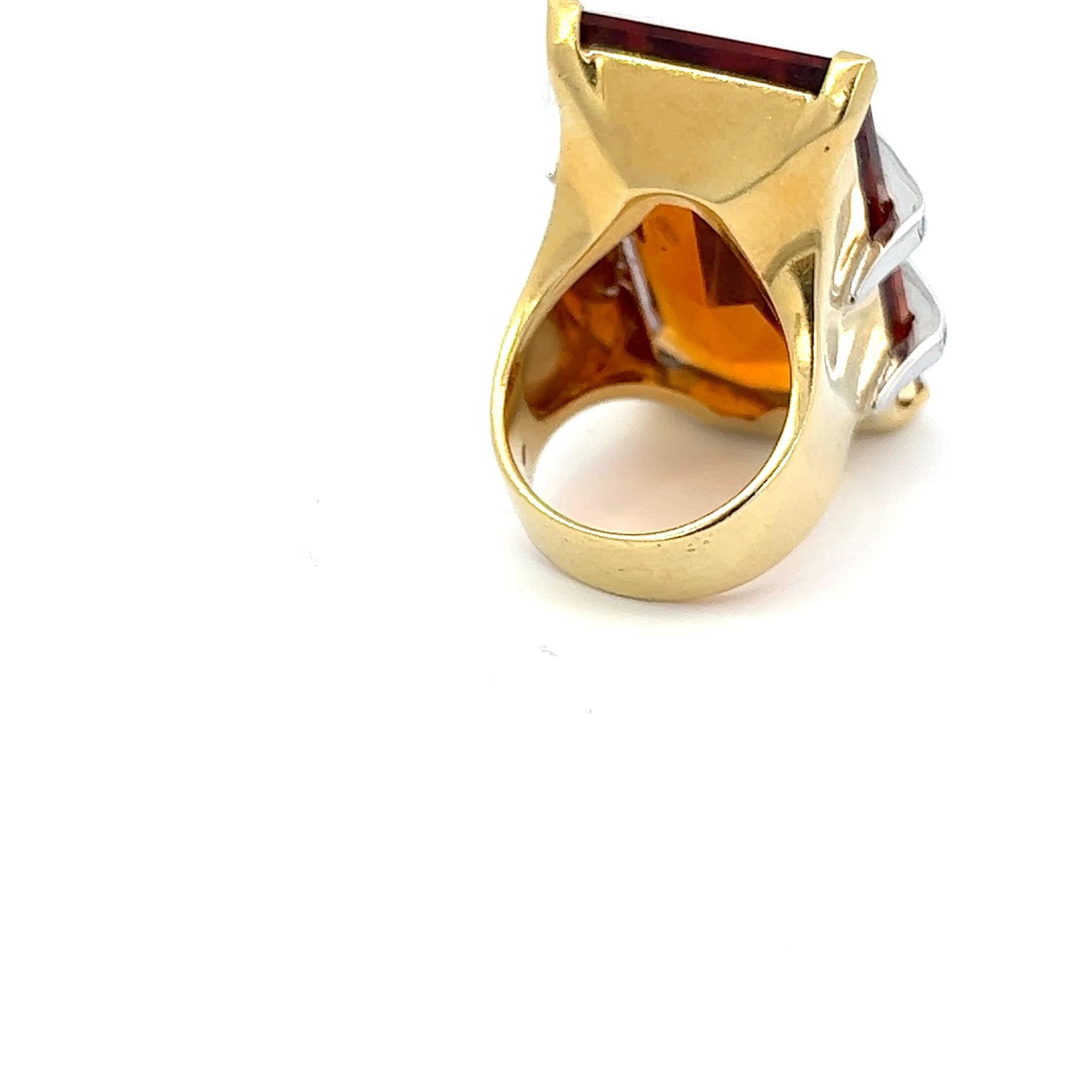 An 18k yellow gold, step-cut Topaz and Diamond ring by Roberto Legnazzi.

Total Diamond weight: circa 0.8ct, graded while in setting.

Origin: Alessandria, Italy.
Age: circa 1970.
Ring size: 57.
Weight: circa 37.2 grams.
Marked with the Italian
