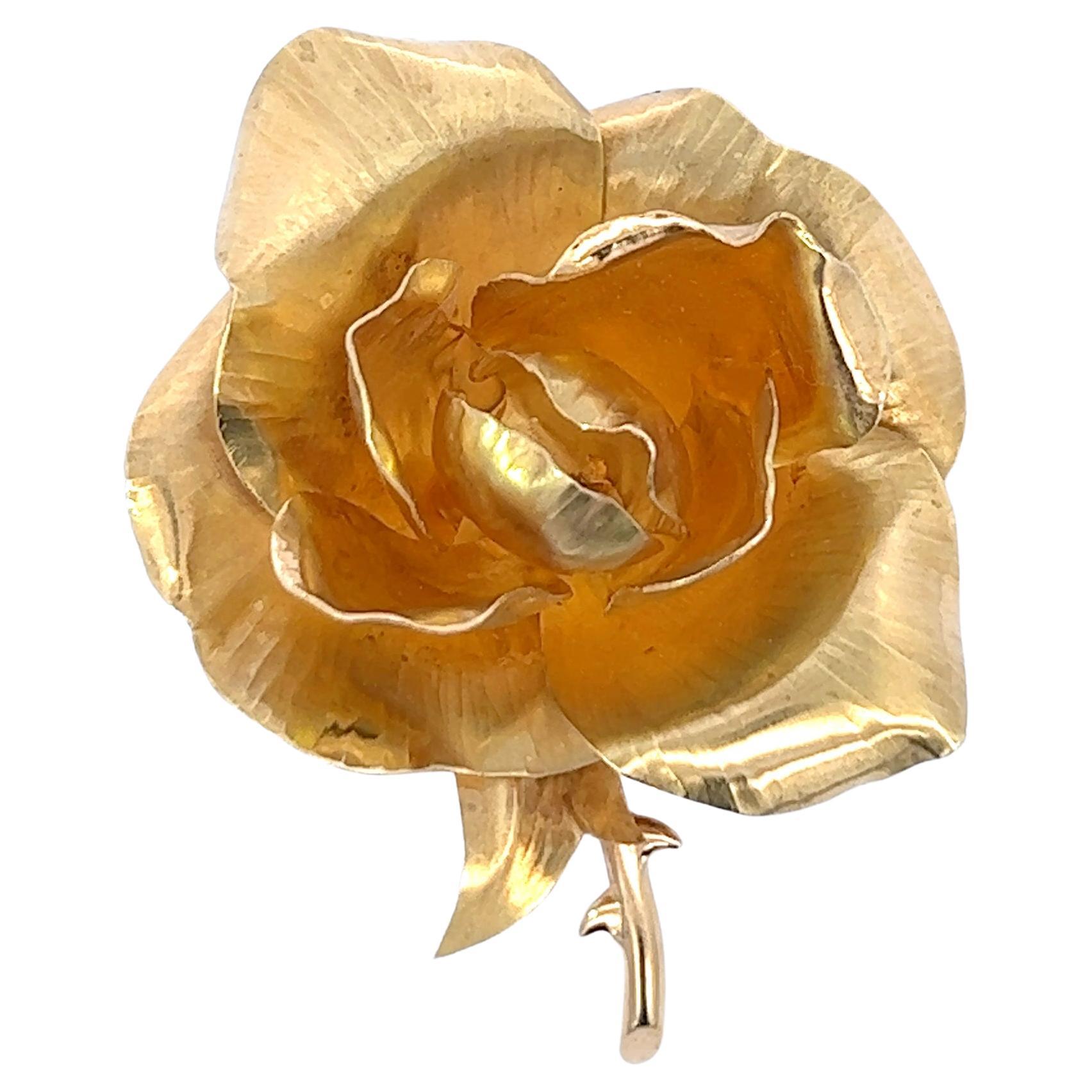 An 18k yellow gold flower brooch by Hermès.