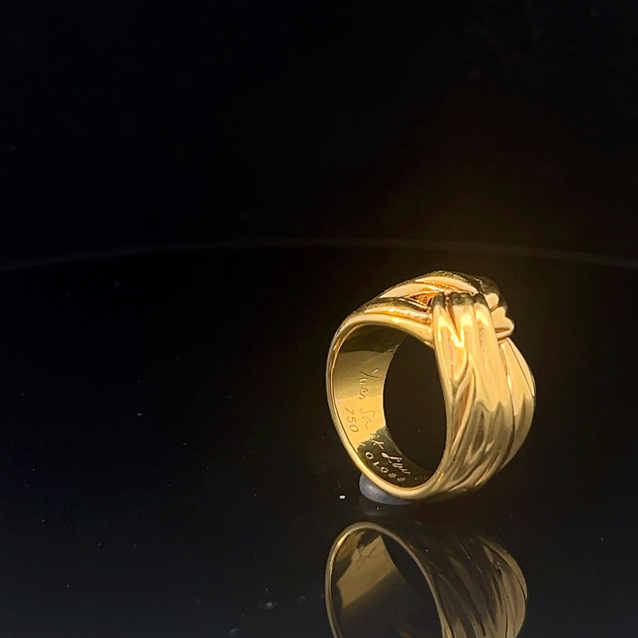 An 18k yellow gold ring by Yves Saint Laurent. 12