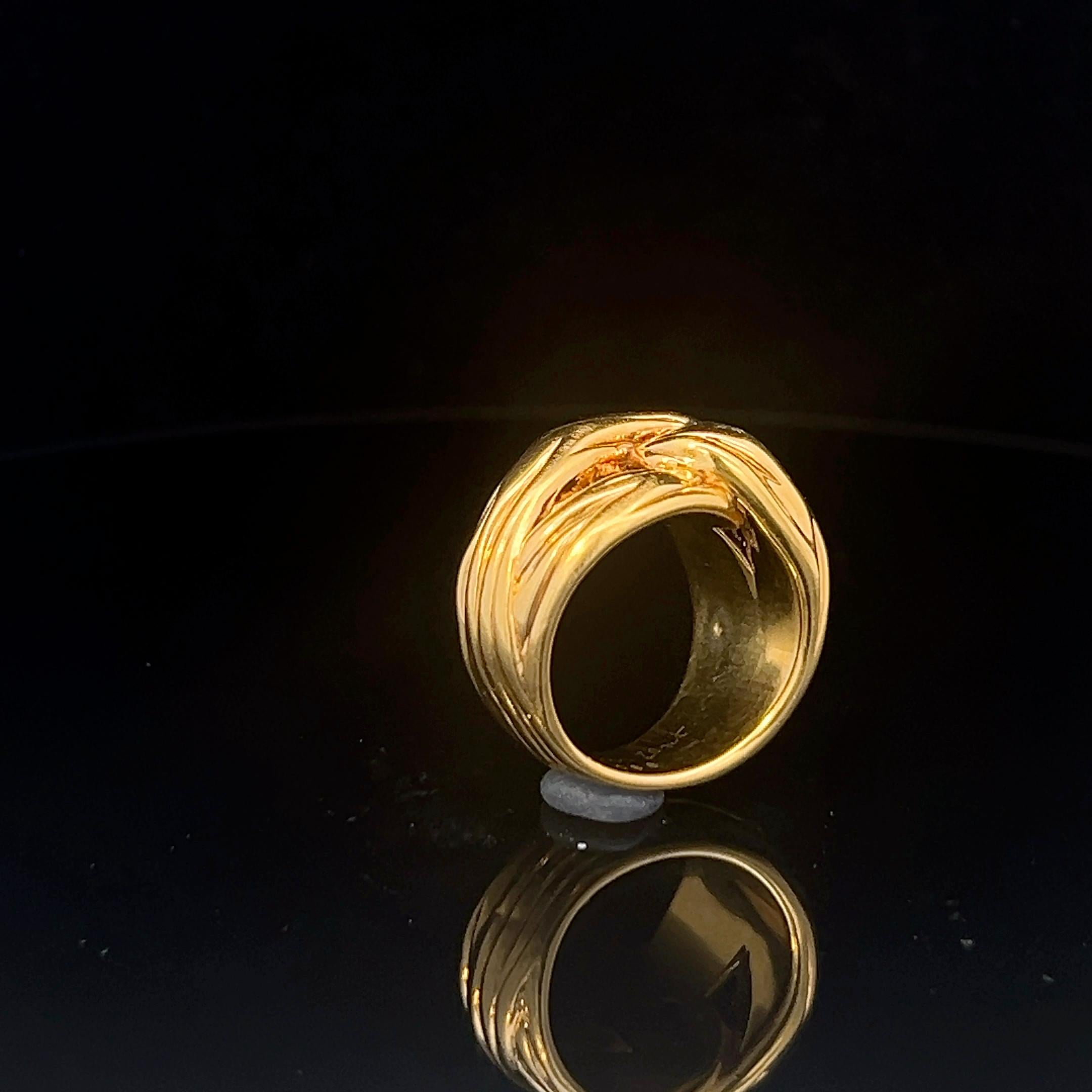 An 18k yellow gold ring by Yves Saint Laurent. 13
