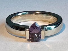 An 18kt White Gold Tension Ring holding a Purple Pear Shaped Spinel of 1.1 Carat