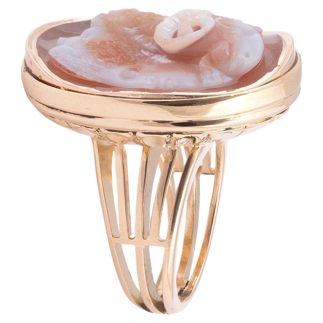 Oval, depicting four conjoined heads: a male youth, a ram, a satyr and a bearded man, within a gold mount, ring size 8
Lenght  28mm, width 25mm
A gryllus is a group of conjoined heads, usually fanciful combinations of beasts and humans, often with
