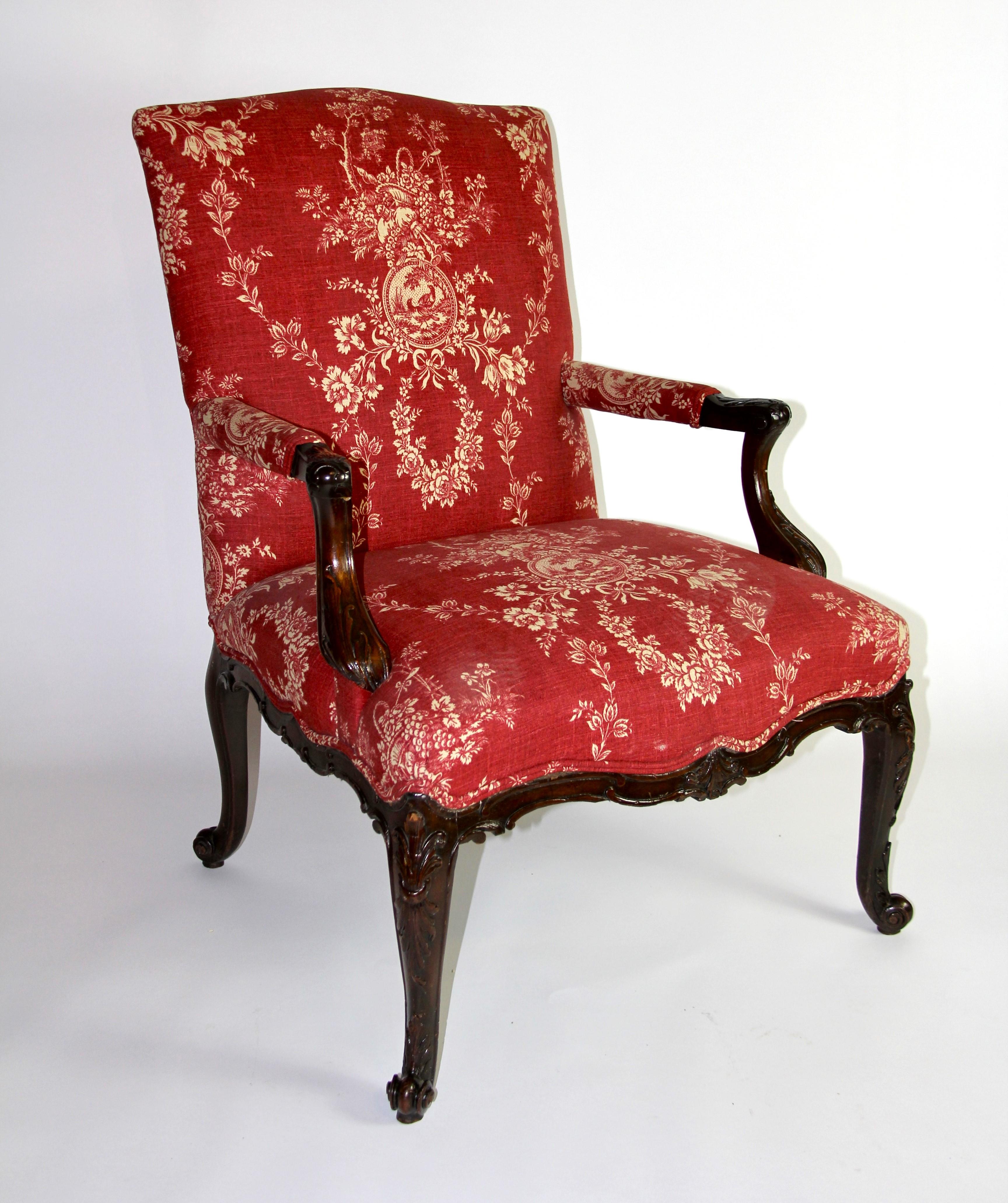 A Beautiful 18th C. English George III Hand-Carved Mahogany Armchair with Red Upholstery.  With a serpentine shaped back and padded arms supported on carved molded downswept supports joined to the upholstered seat over a serpentine shaped and molded