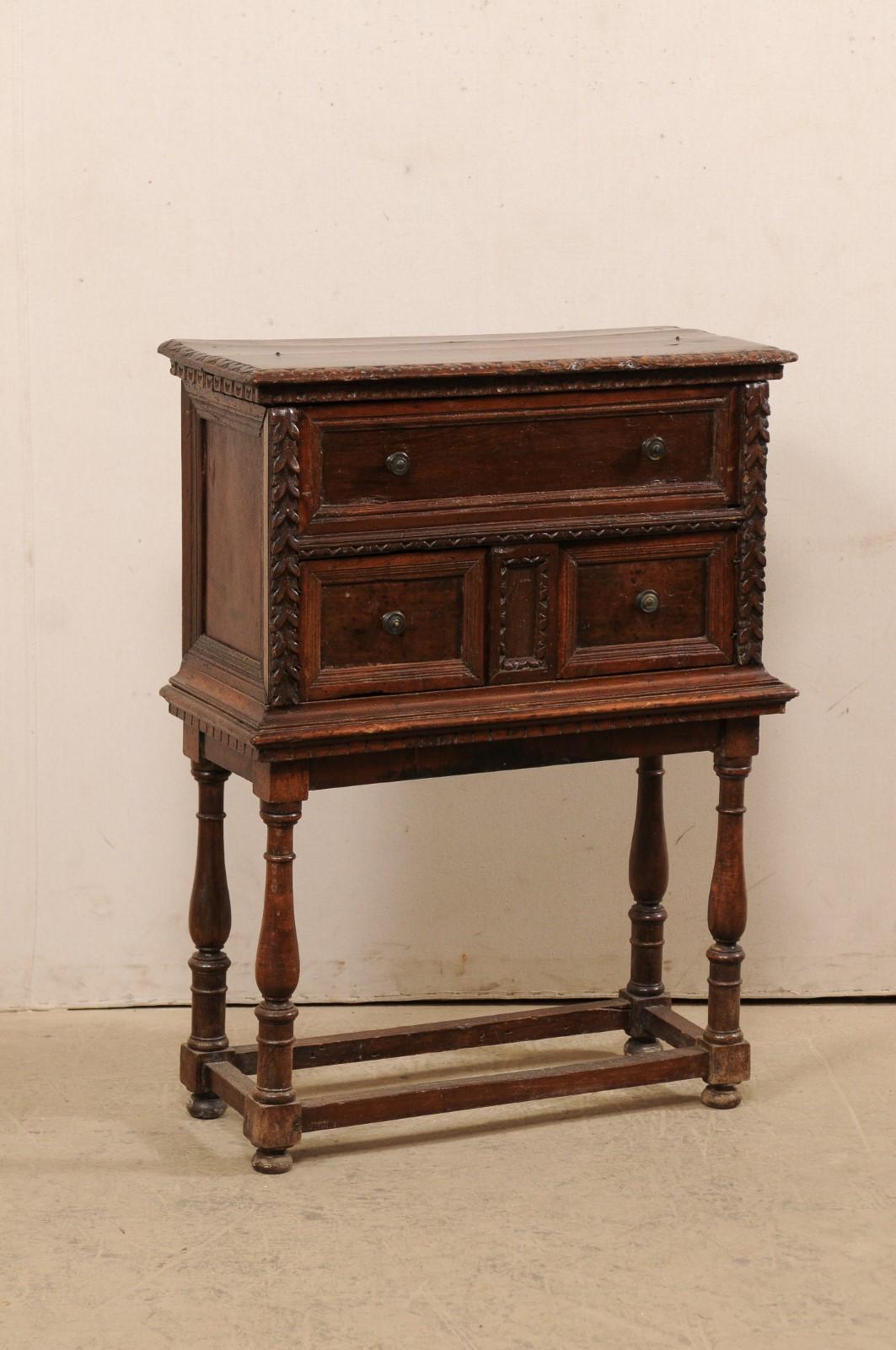 An Italian butler's desk from the 18th century raised on later base. This antique case piece from Italy has the appearance of being a three drawer chest at first glance. However, upon closer inspection, the upper 
