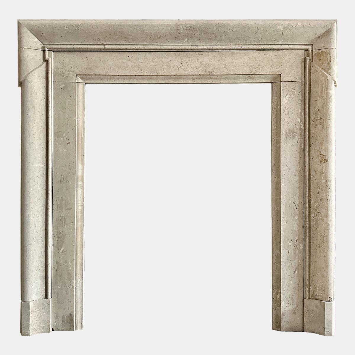 A tall and unusual architectural designed Bolection style fireplace in Portland Roach stone, known for its heavy fossil content. The frame with a  gentle curved moulding and the header cut with a 