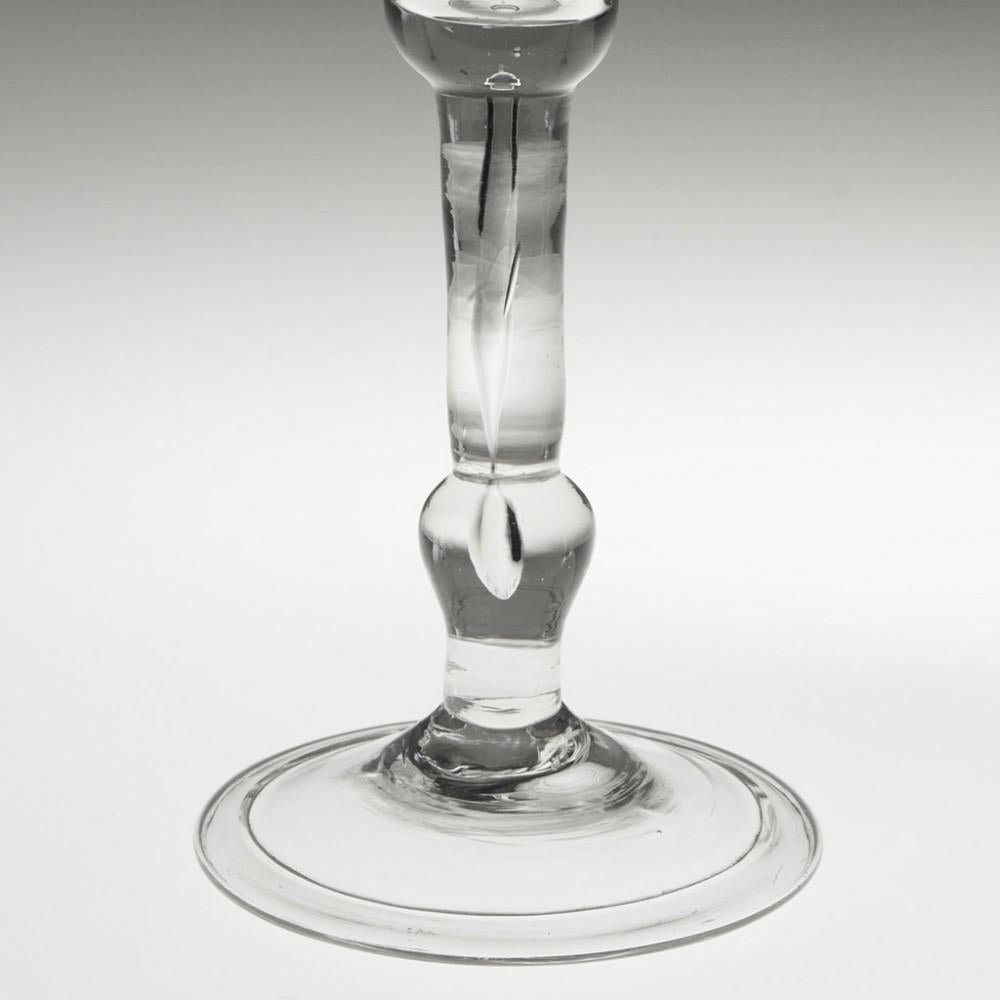 Heading : Balustroid Stem Kit-Cat Type Wine Glass
Period : c1740
Origin : England
Colour : Clear
Bowl : Bell
Stem :  Inverted baluster knop towards the base of the stem, elongated air tear
Foot : Folded conical
Pontil : Snapped
Glass Type :