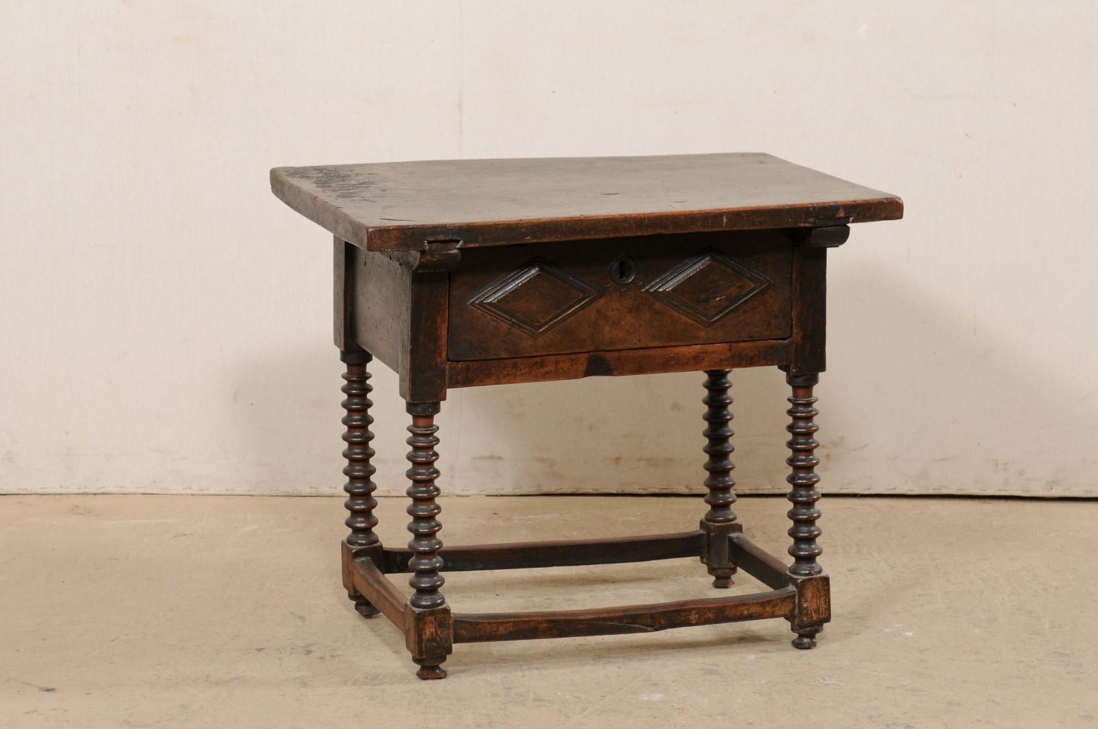 An Italian carved-walnut wood occasional table with single drawer, from the 18th century. This antique table from Italy, created from rich walnut wood, has a rectangular-shaped top, which overhangs the apron below which houses a single drawer at one