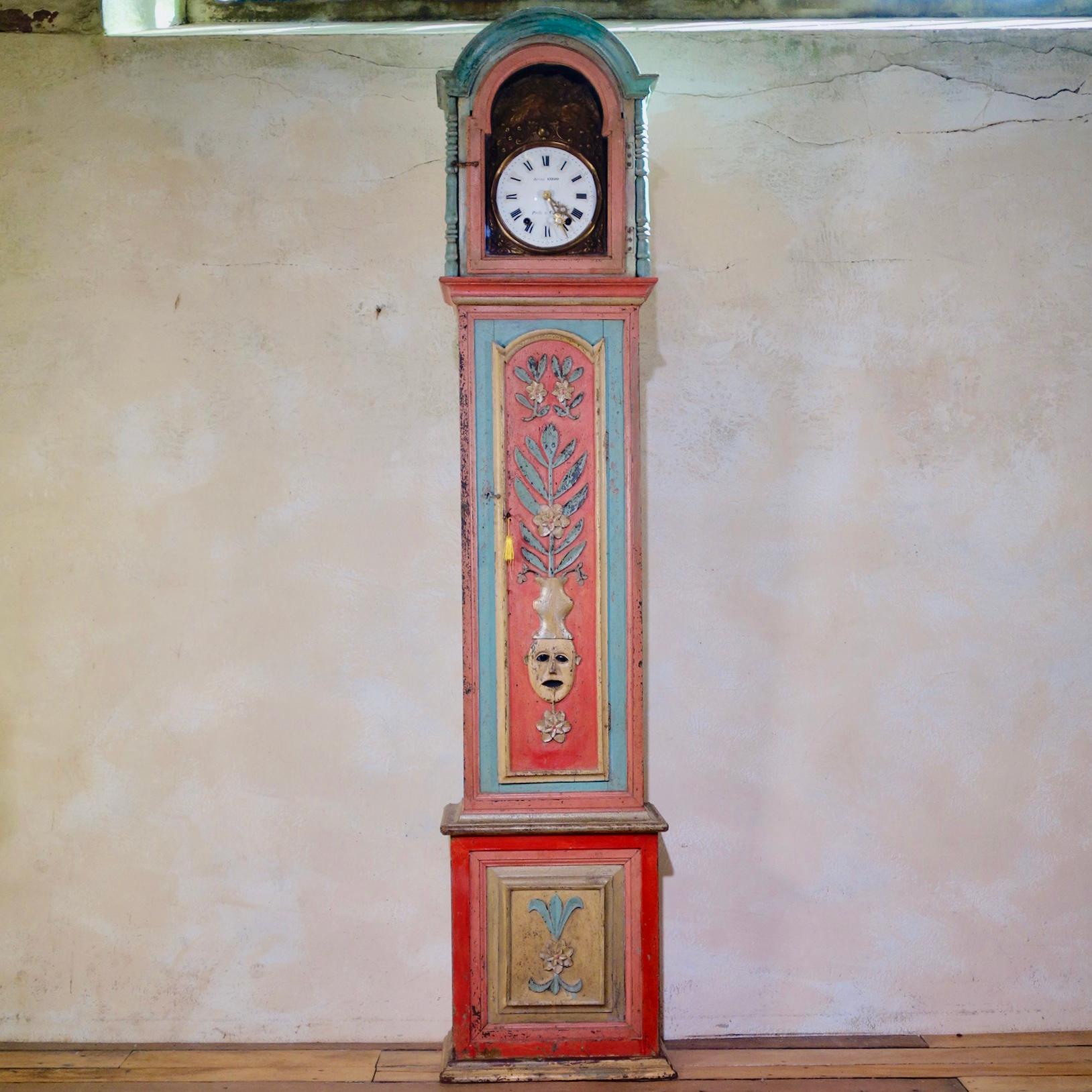 An 18th Century Portuguese painted chestnut longcase clock with hand-carved decorations. A very striking design featuring its original paint of vivid pastel-like colors. 

The eight-day birdcage movement striking on a bell, with an arched enameled