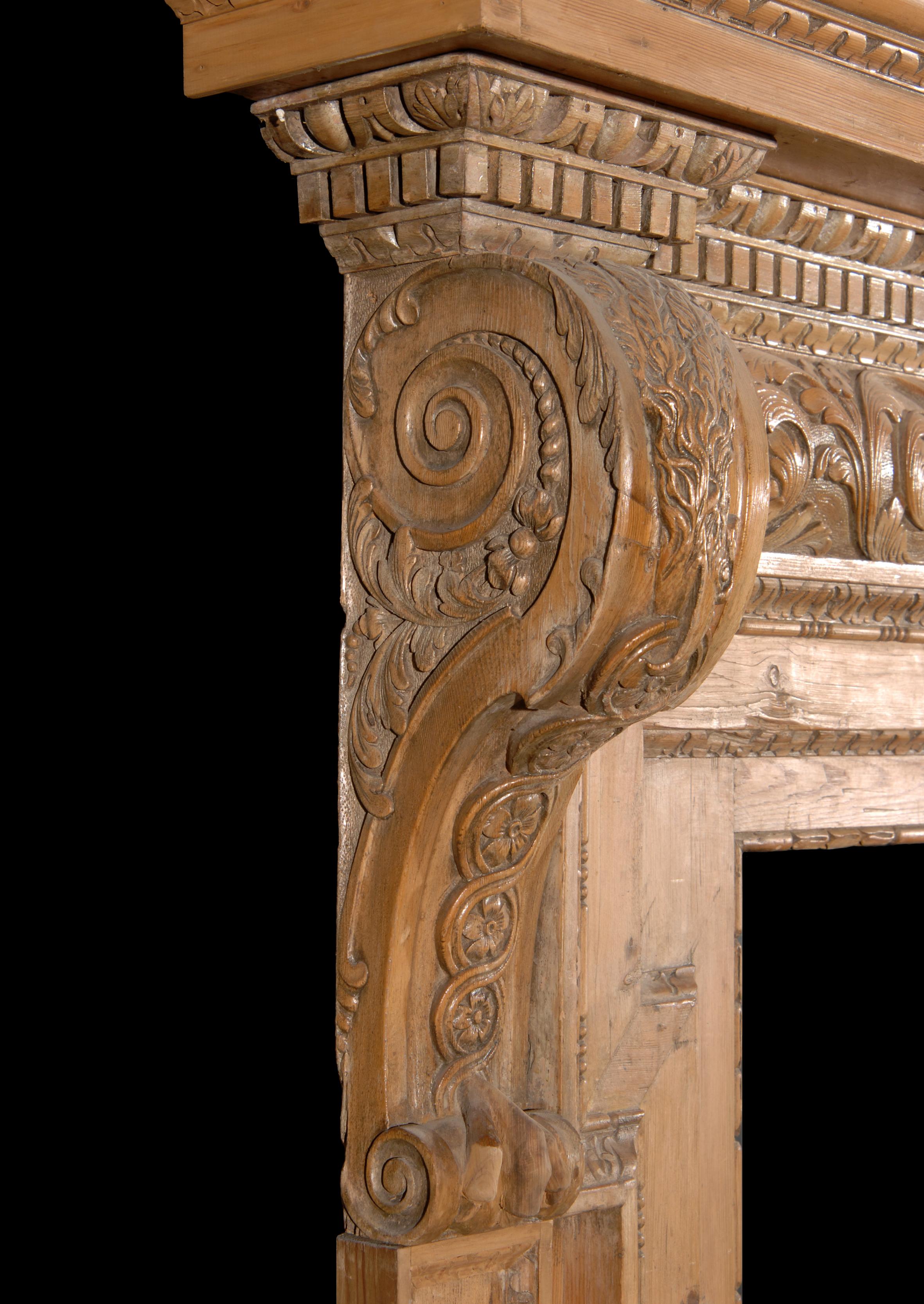 An 18th century (circa 1750) George II pine doorway. The barrel frieze carved with shell centre and scrolled leaves and foliage, surmounted by egg and dart dentil cornice. Panelled pilaster jambs with small leaf moulding, drapped eagles to the