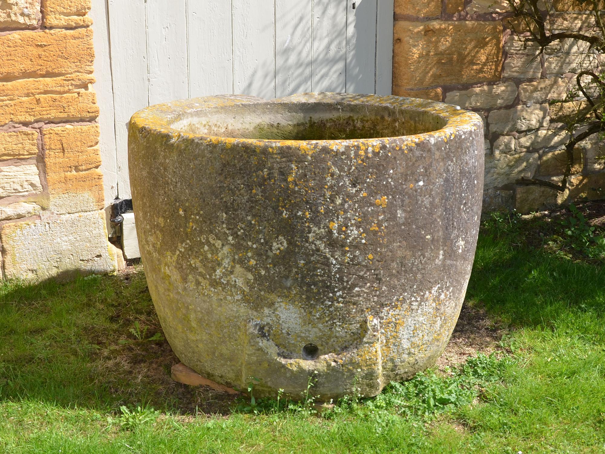An 18th century circular stone trough with good weathering and patination.