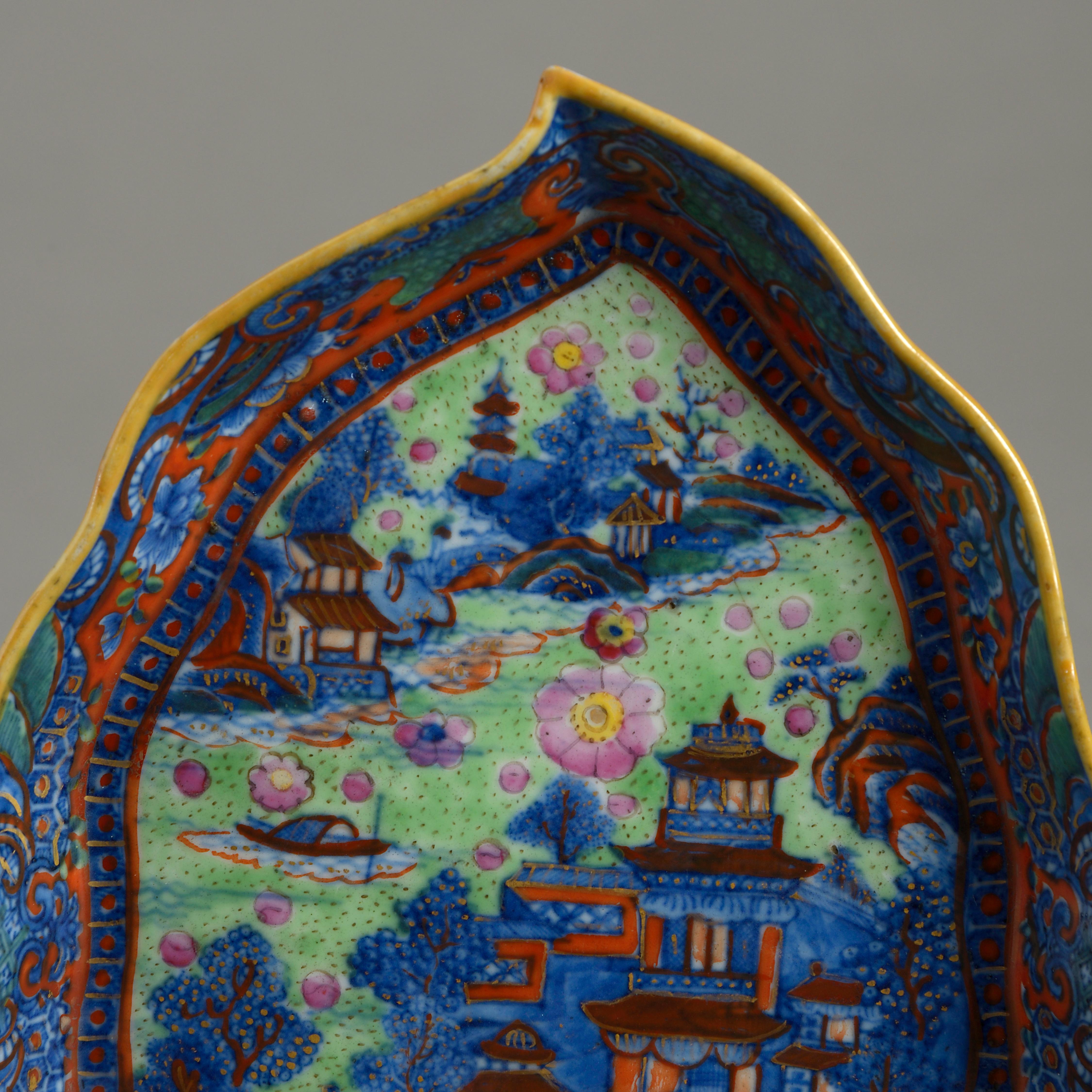 A charming late 18th century Chinese Export clobbered porcelain leaf dish, the surface decorated with over-glazes in vivid reds, blues, greens, and pinks.

Qing Dynasty, Qianlong Period