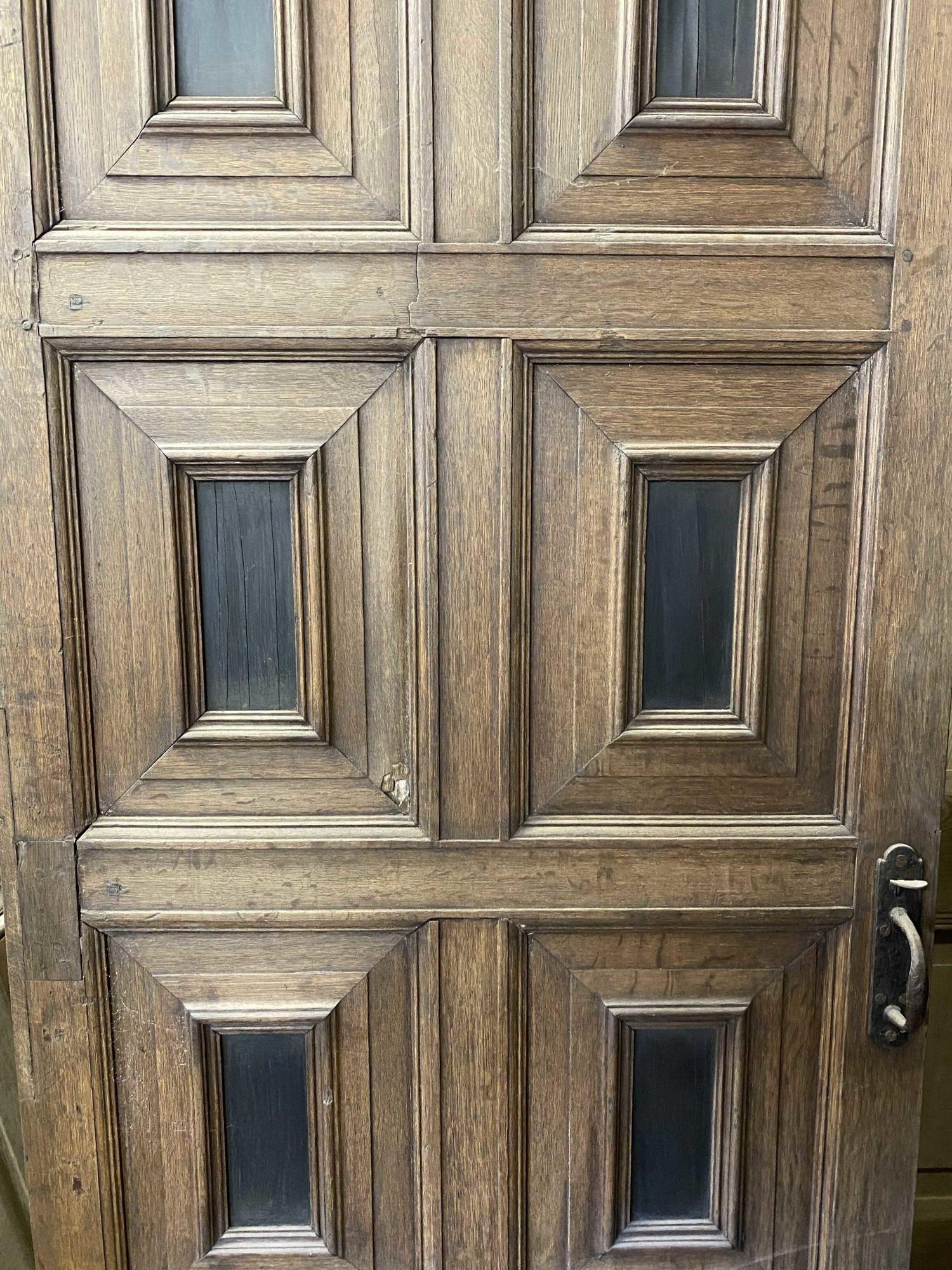 A lovely antique door, salvaged from a country house in Kent. This door is of oak construction, with ebony panels.
