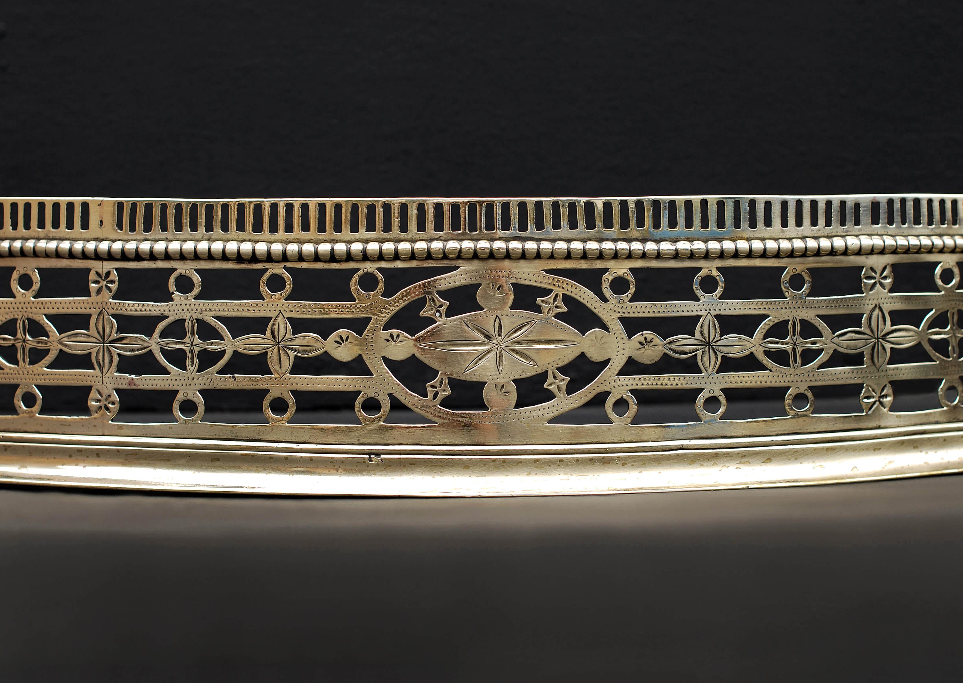 An attractive 18th century engraved brass sepertine fender, with circle and flower pattern, beaded moulding and small flutes to top. 

External Width:	1240 mm      	48 ⅞