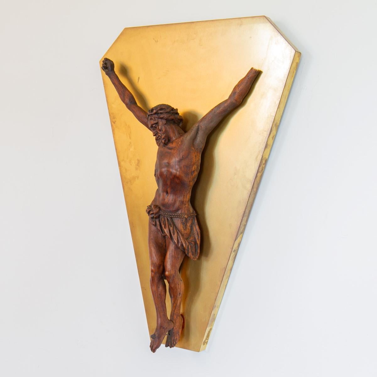 An 18th century Flemish carved figure of Christ mounted to a brass wall panel 

one hand missing.