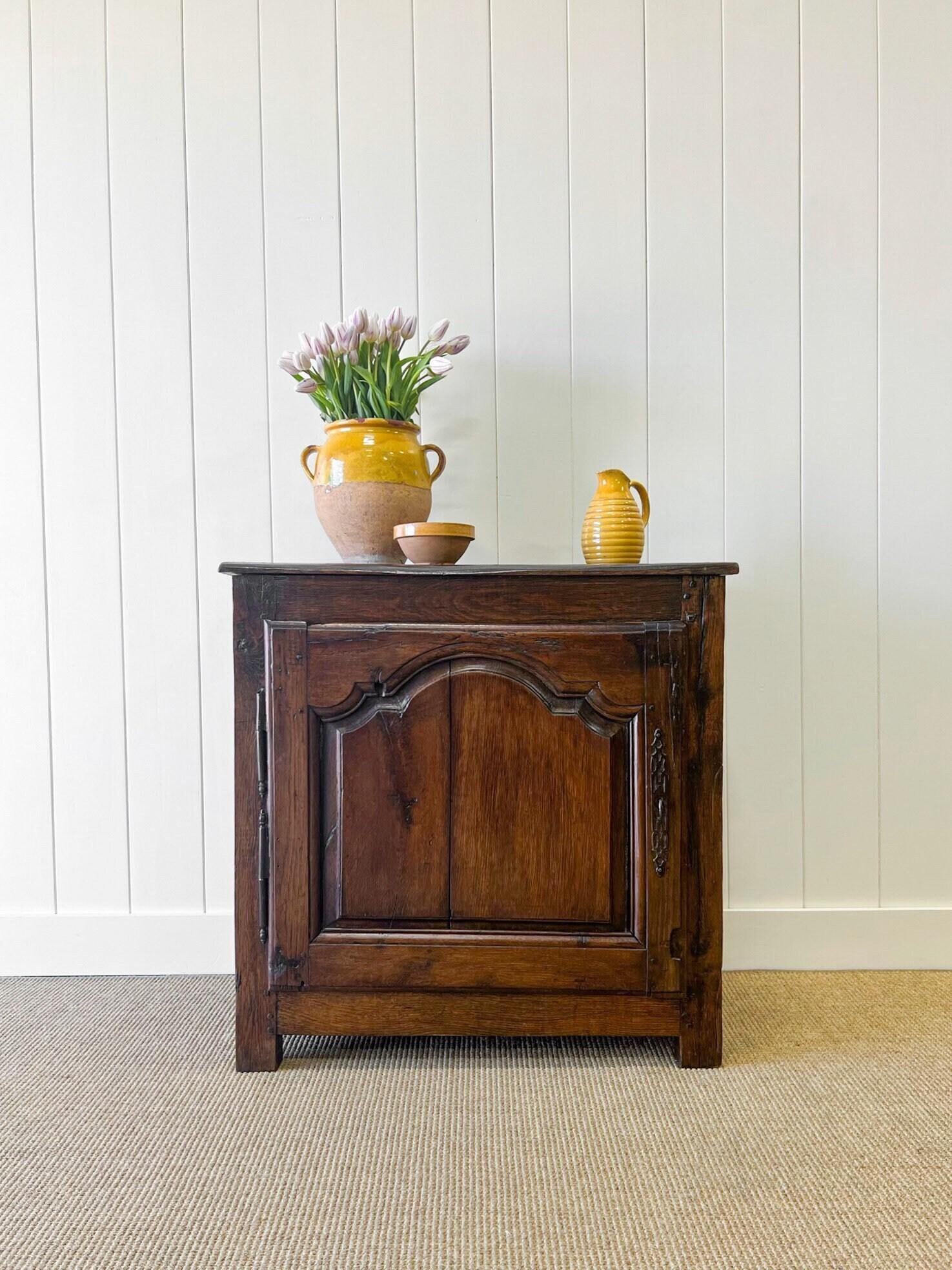 An antique French country buffet or sideboard. A wonderful surface with wear in all the right places. Beautiful hardware and hinges. Lovely paneled doors. Paneled sides. A solid base. Pegged Construction. Strong and sturdy in joint and ready for
