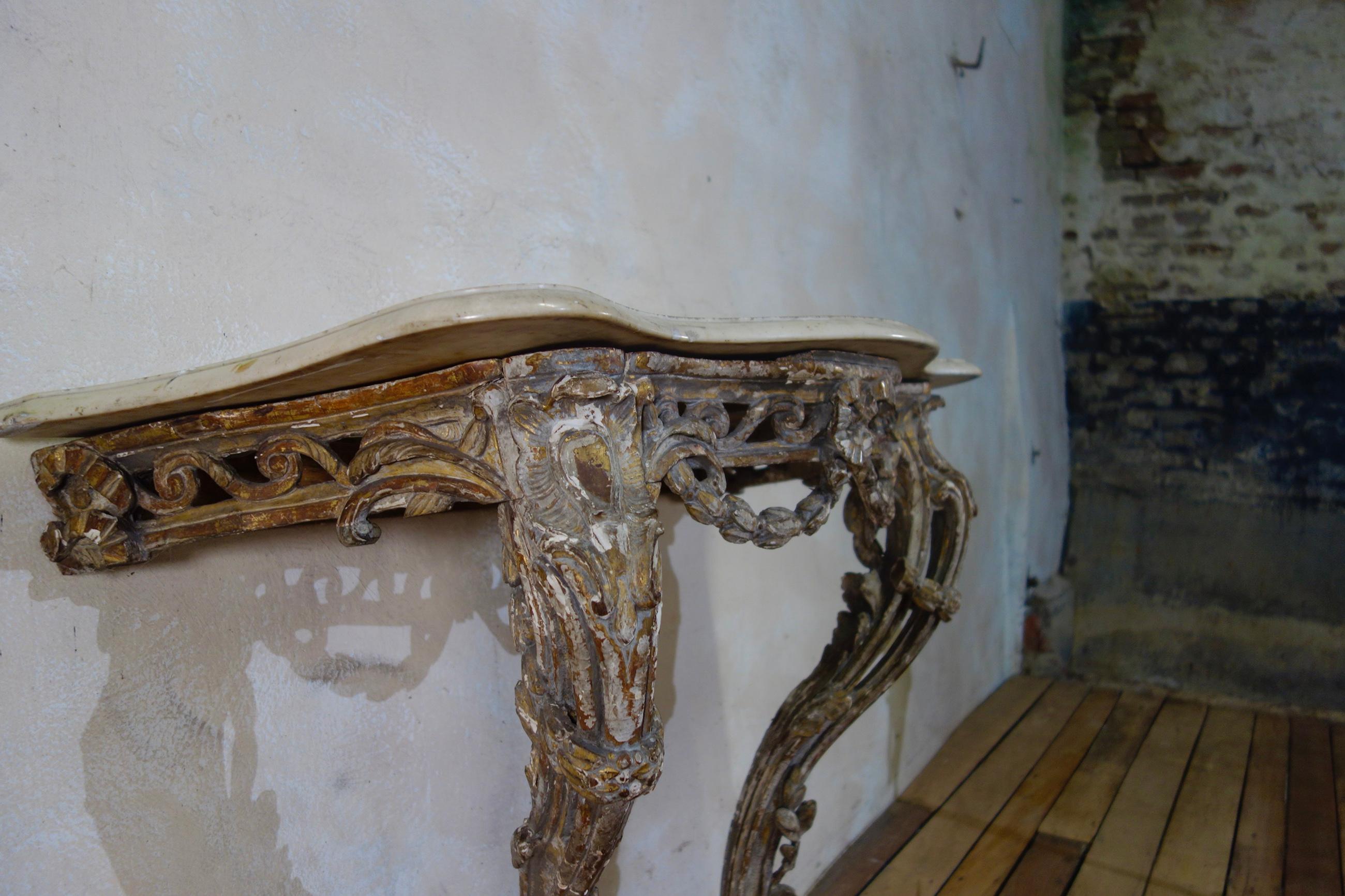 A superb 18th century French marble-topped console table. A fabulous example of 18th century craftsmanship, featuring original paintwork throughout displaying subtle blue and grey tones with original gilding to the pierced and carved base.
This