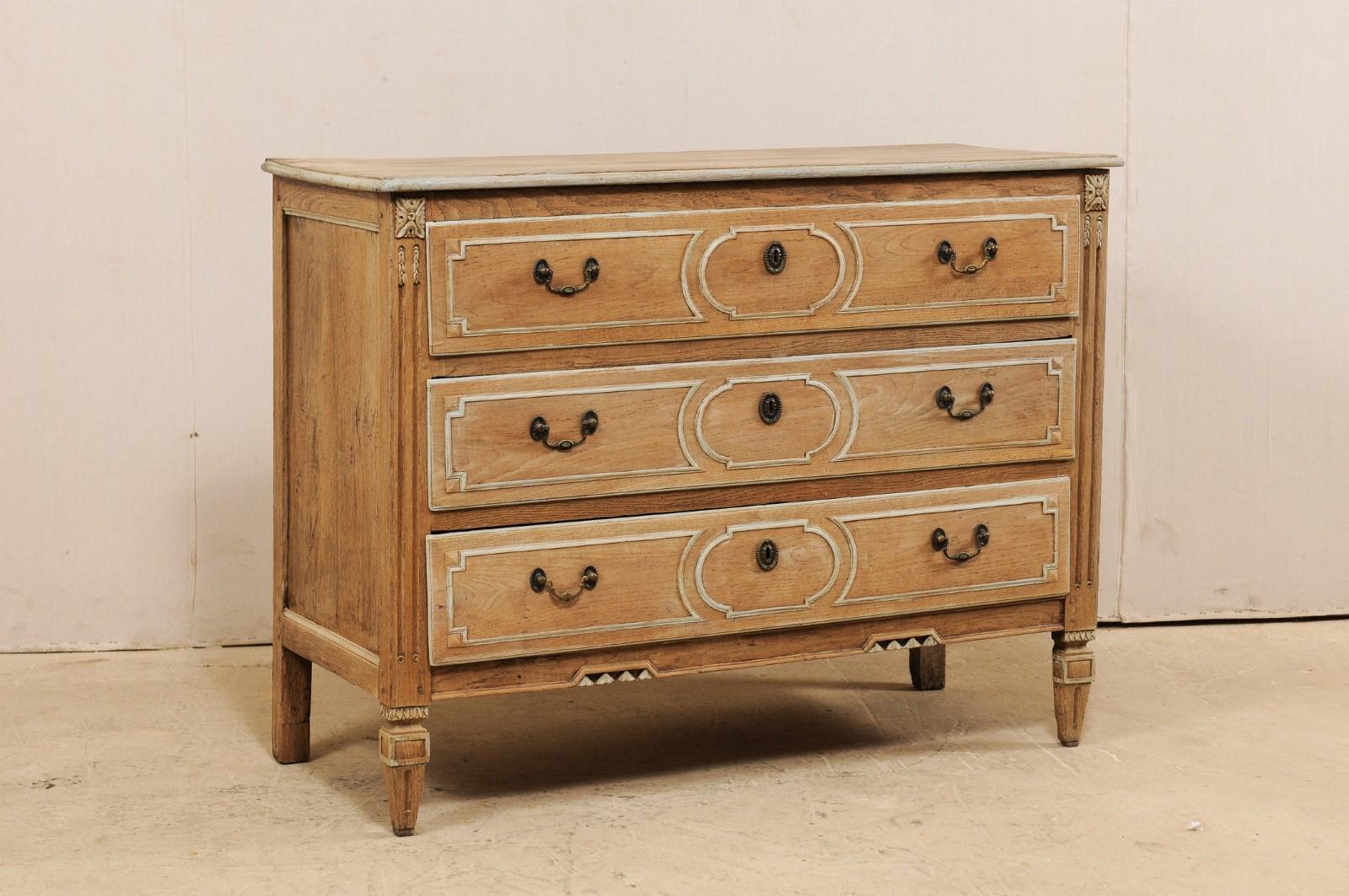 A beautiful 18th century French oak chest of three drawers. This antique chest from France features three decoratively panel carved front drawers, fluted front side posts, adorned in carved accents along side posts and center of it's skirt, and is