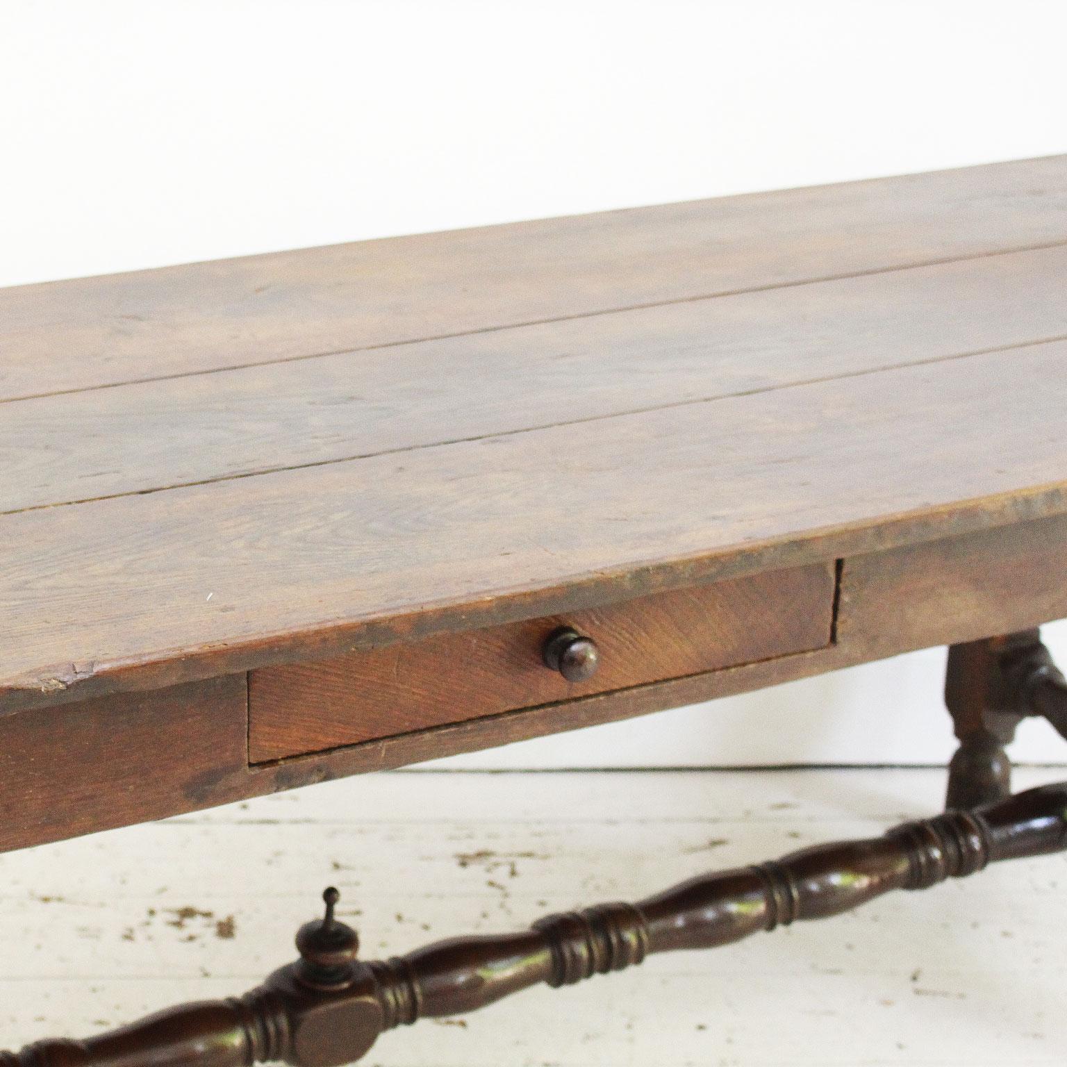 This very attractive antique 18th century oak refectory dining table has turned legs, a three plank top and comfortably seats 8 - 10 people. Excellent color and patination. The centre stretcher is also turned and is adorned with an unusual carved