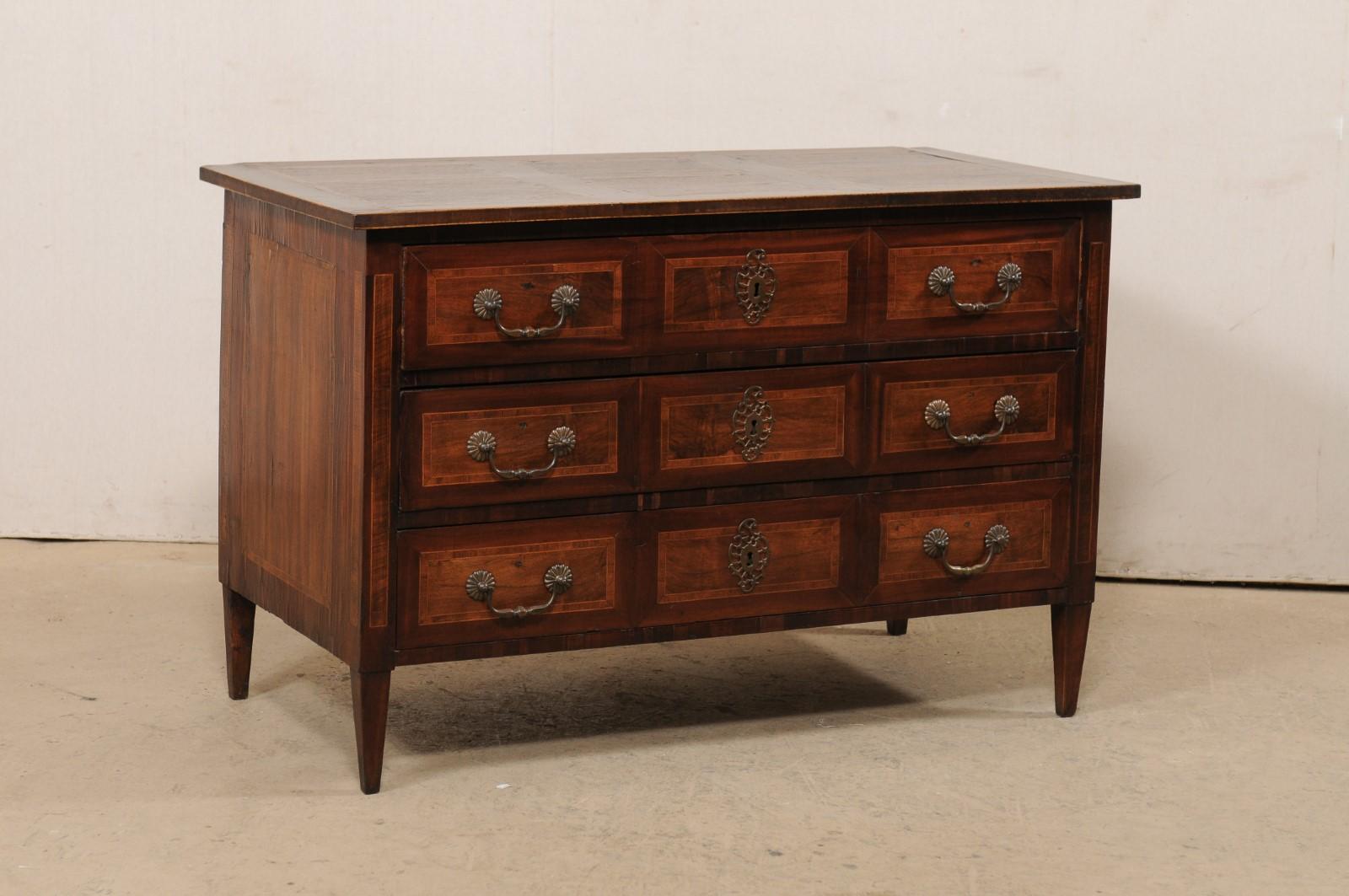 A French wood chest of three drawers, with beautiful veneers and inlay, from the 18th century. This antique commode from France was designed in nice clean lines, allowing the beautifully veneered wood grain and inlay banding to speak for the simple