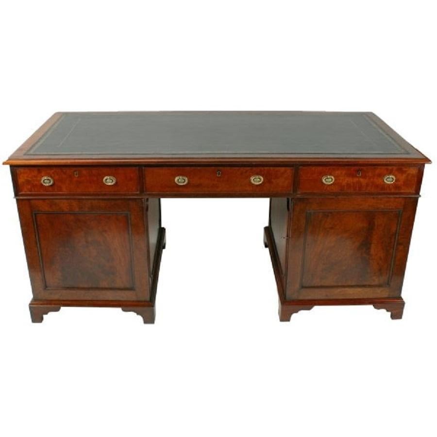 An 18th century Georgian mahogany pedestal desk.


The desk has a gold tooled black leather writing surface, three drawers across the front and two cupboards.


The left hand cupboard has four drawers inside and the right hand cupboard has two