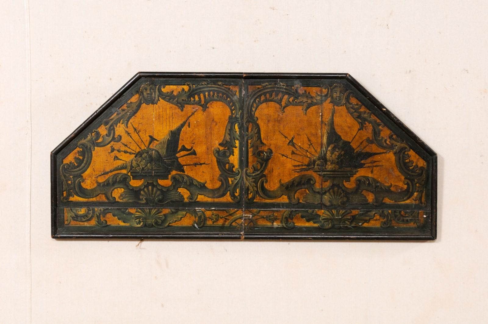 An Italian hand-painted wall plaque from the 18th century. This wall decoration from Italy has a half-octagon shape with longer flat section being at bottom-side of plaque. It has been hand-painted in a motif of horns, arrows, angels, and volutes.