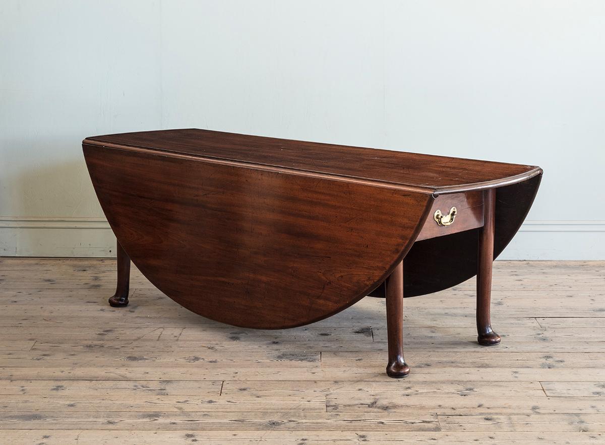 Carved An 18th Century Large Scale Drop Leaf Dining Table with Robust Pad Feet For Sale