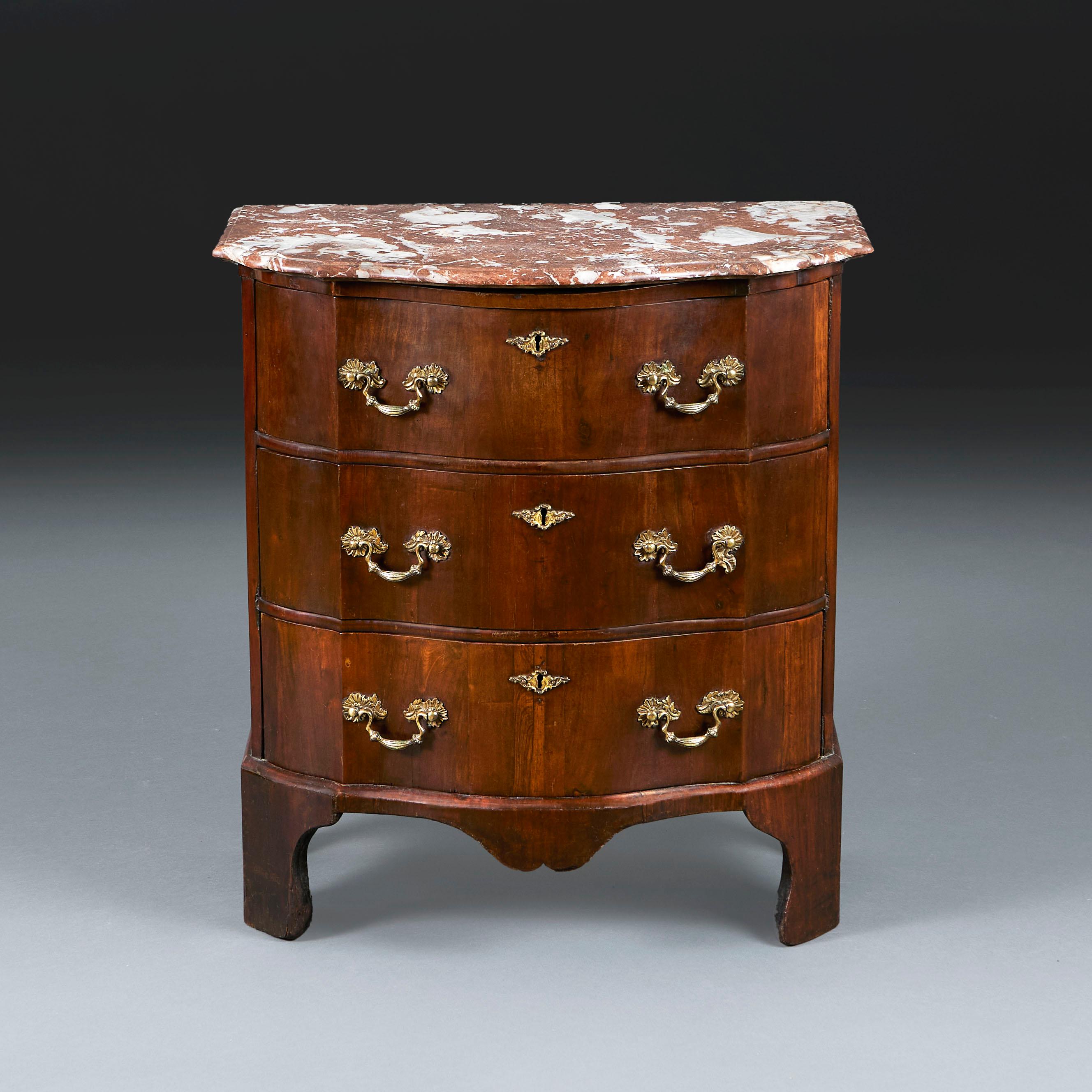 France, circa 1750

A mid eighteenth century bedside commode with serpentine front, opening with three drawers, retaining the original red marble top, and all supported on bracket feet.

Height 76.00cm
Width 70.00cm
Depth 41.00cm