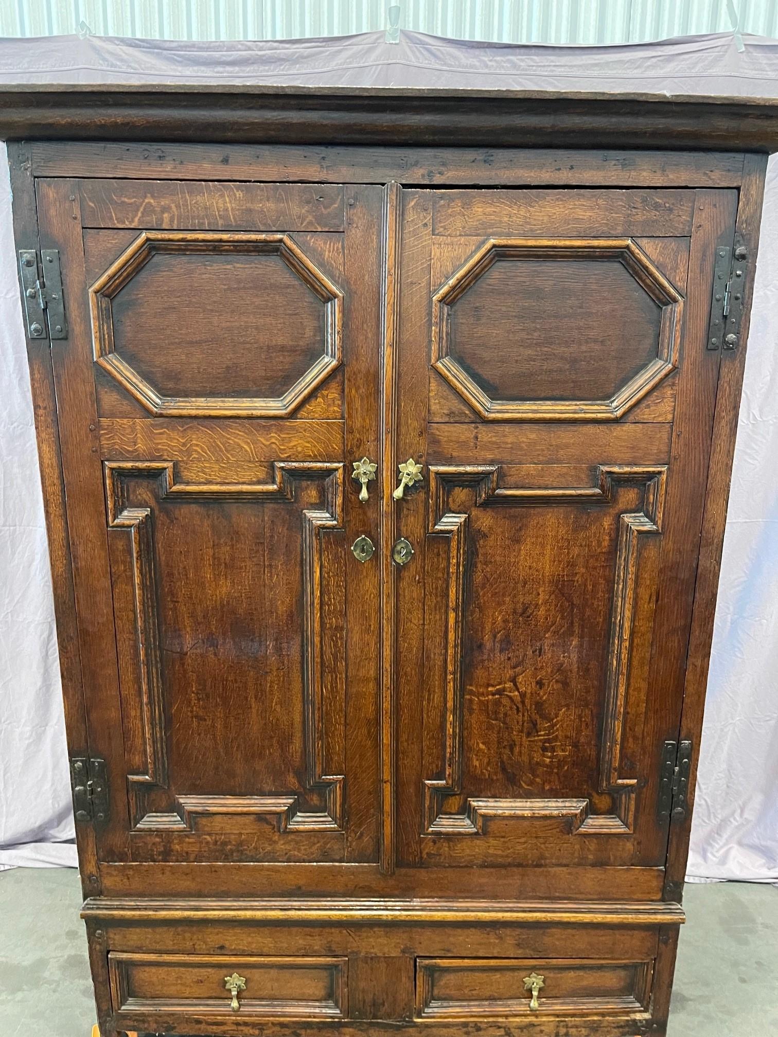A splendid example of a 18th Century Georgian oak cupboard from around 1760. The exterior shell is genuine and untouched, with the interior have some modifications and improvements added through the years. The right side door opens to a compartment