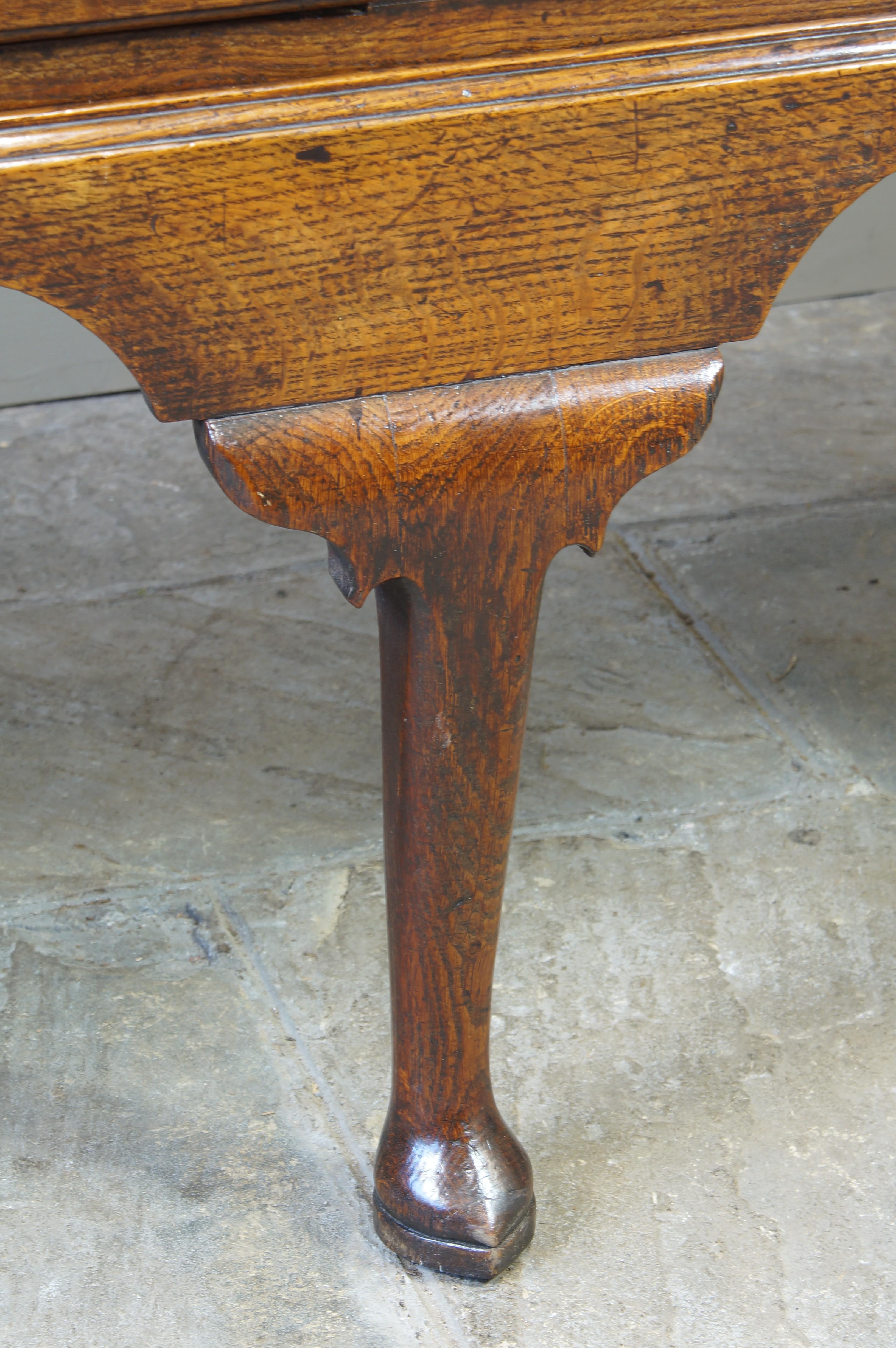 An Excellent George II Oak Dresser base of a fabulous untouched colour and patina. With a boldly shaped apron, three well shaped cabriole legs to the front and square legs to the back The drawer fronts finished with a lip mould, this feature was