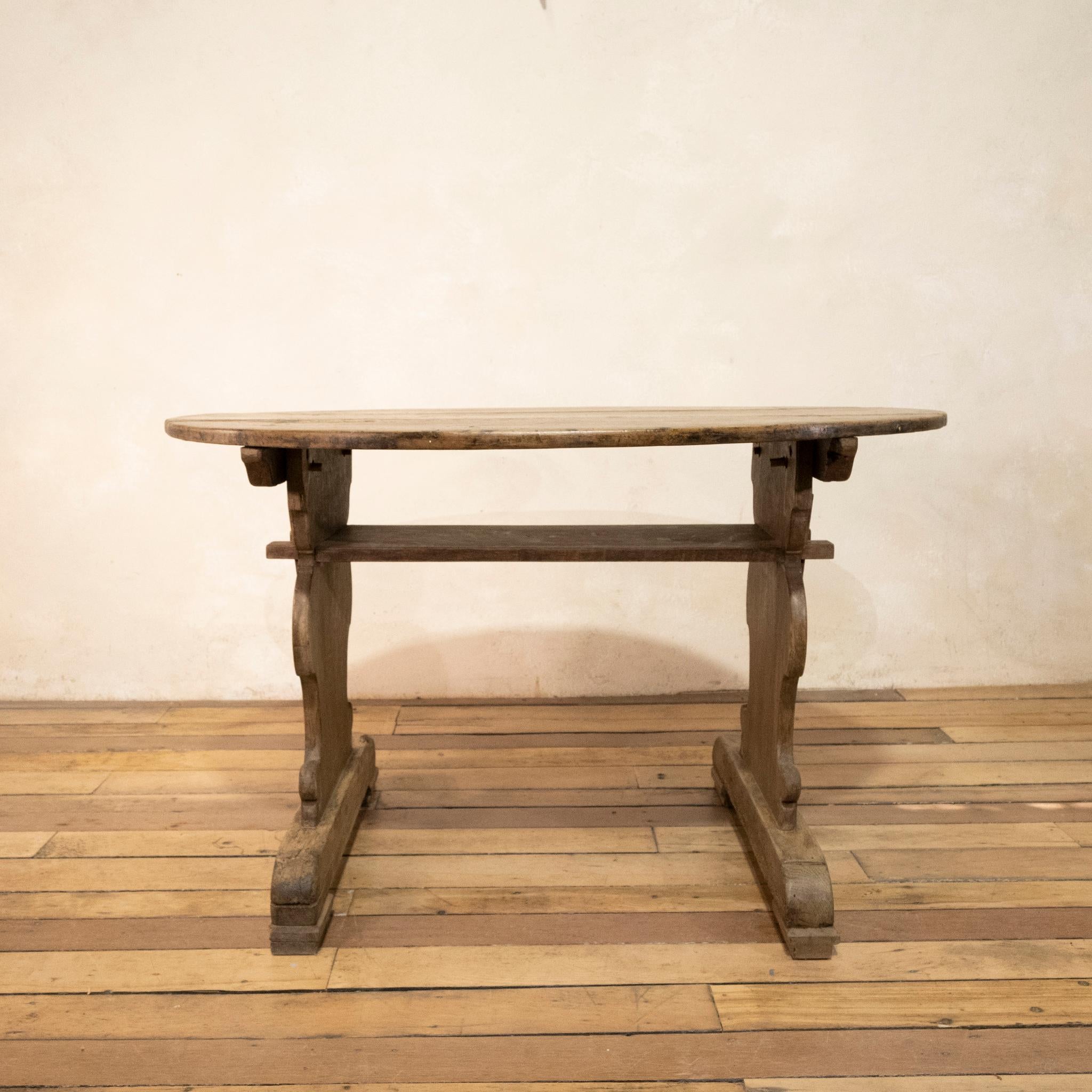 An oval late 18th-century Swedish folk art oak and Walnut Tressel 'Bockbord' table. Featuring a removable oval top raised on T-shaped ends, sat on sledge feet. This table can be easily disassembled for transport, secured by peg and brace fastenings.