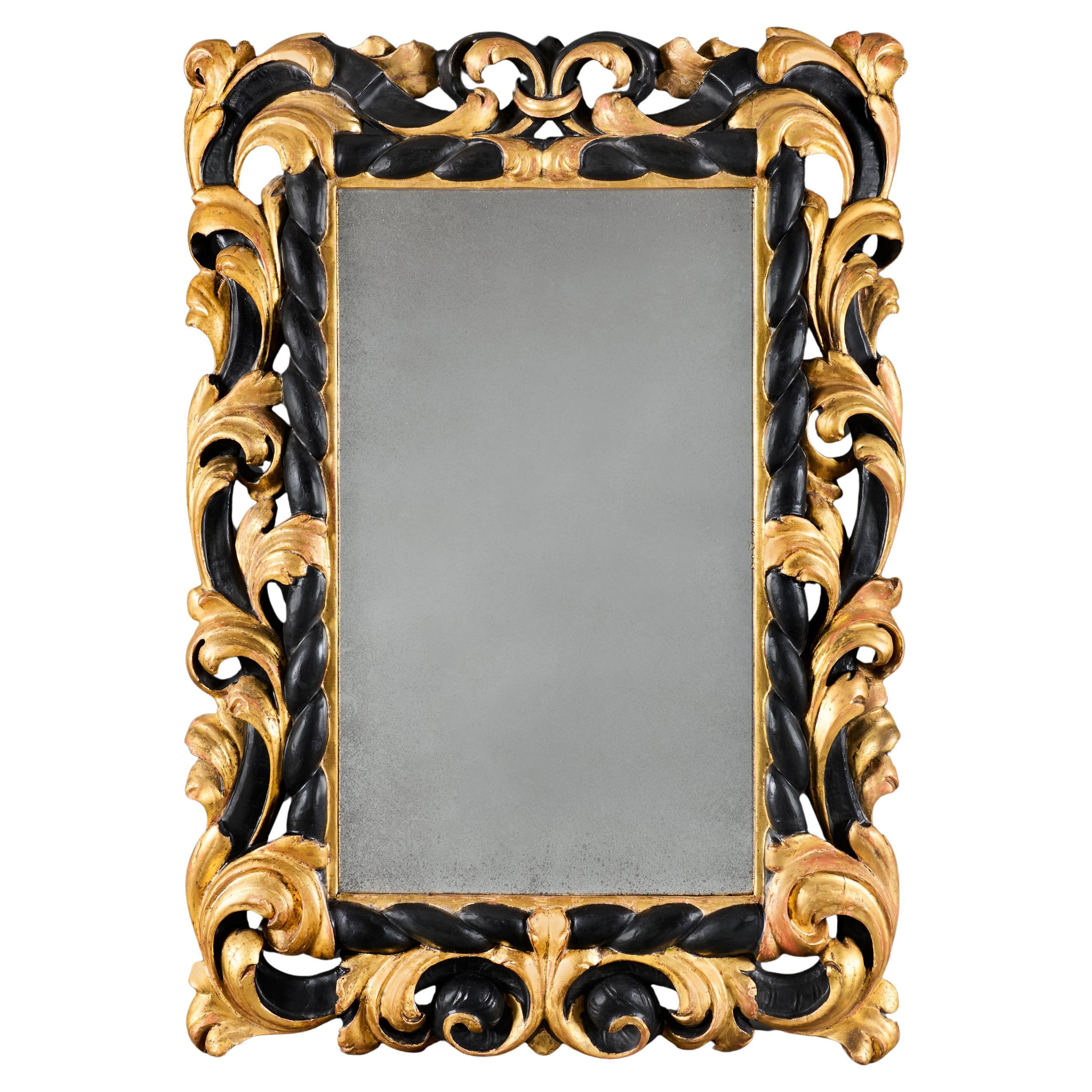 An 18th Century Tuscan Giltwood and Ebonised Mirror