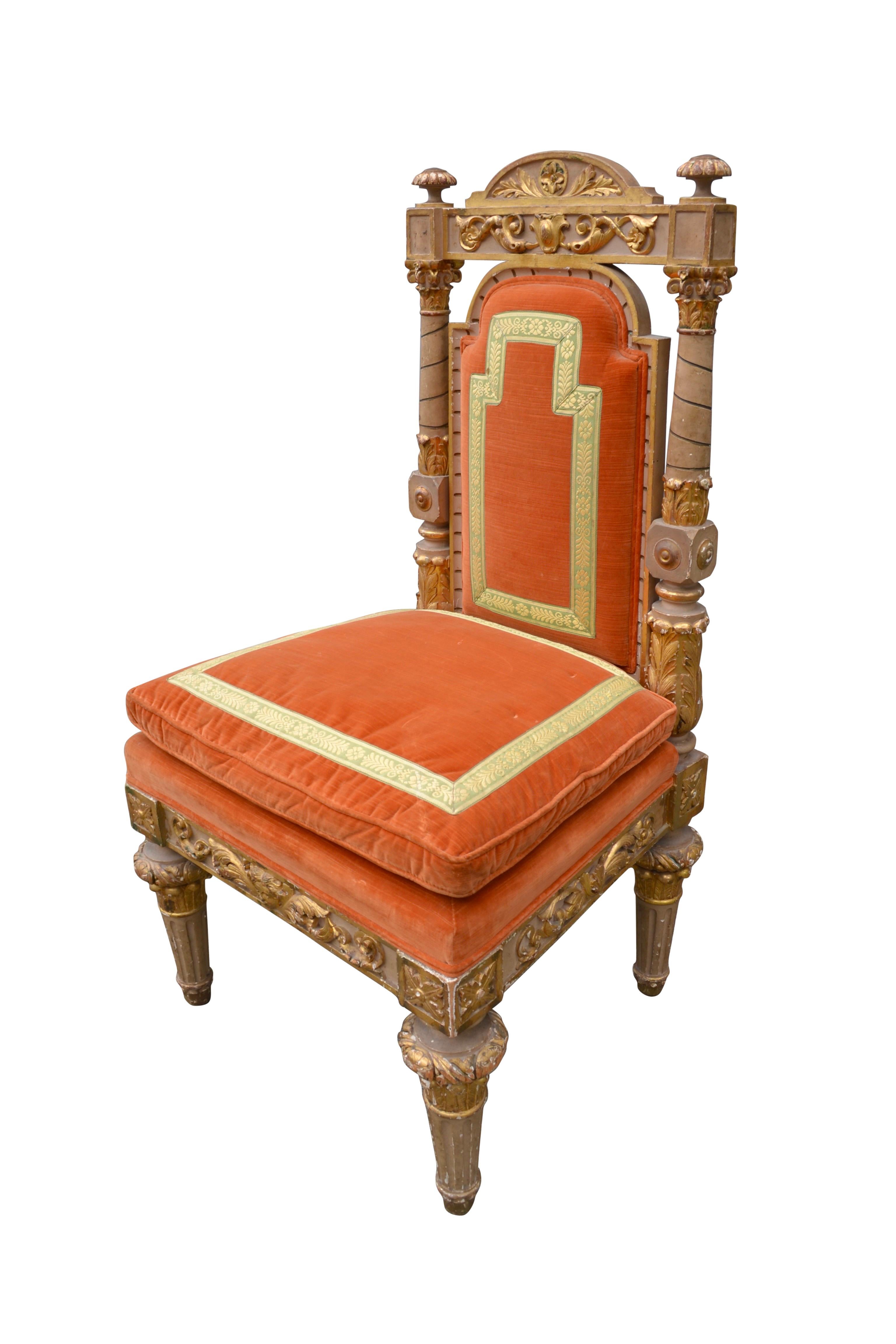A beautifully carved large scale Piedmontese chair with a cream painted and gilt decorated frame. The shield shaped back has two circular highly carved columns to each side, below a deeply carved top chair rail with a curved pediment. The chair seat