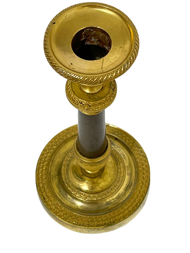 An 19th century French candle stick

An bronze with gilt candlestick

The candlestick measures 21 cm high and the foot 10 cm diagonal
The weight is 384 gram.