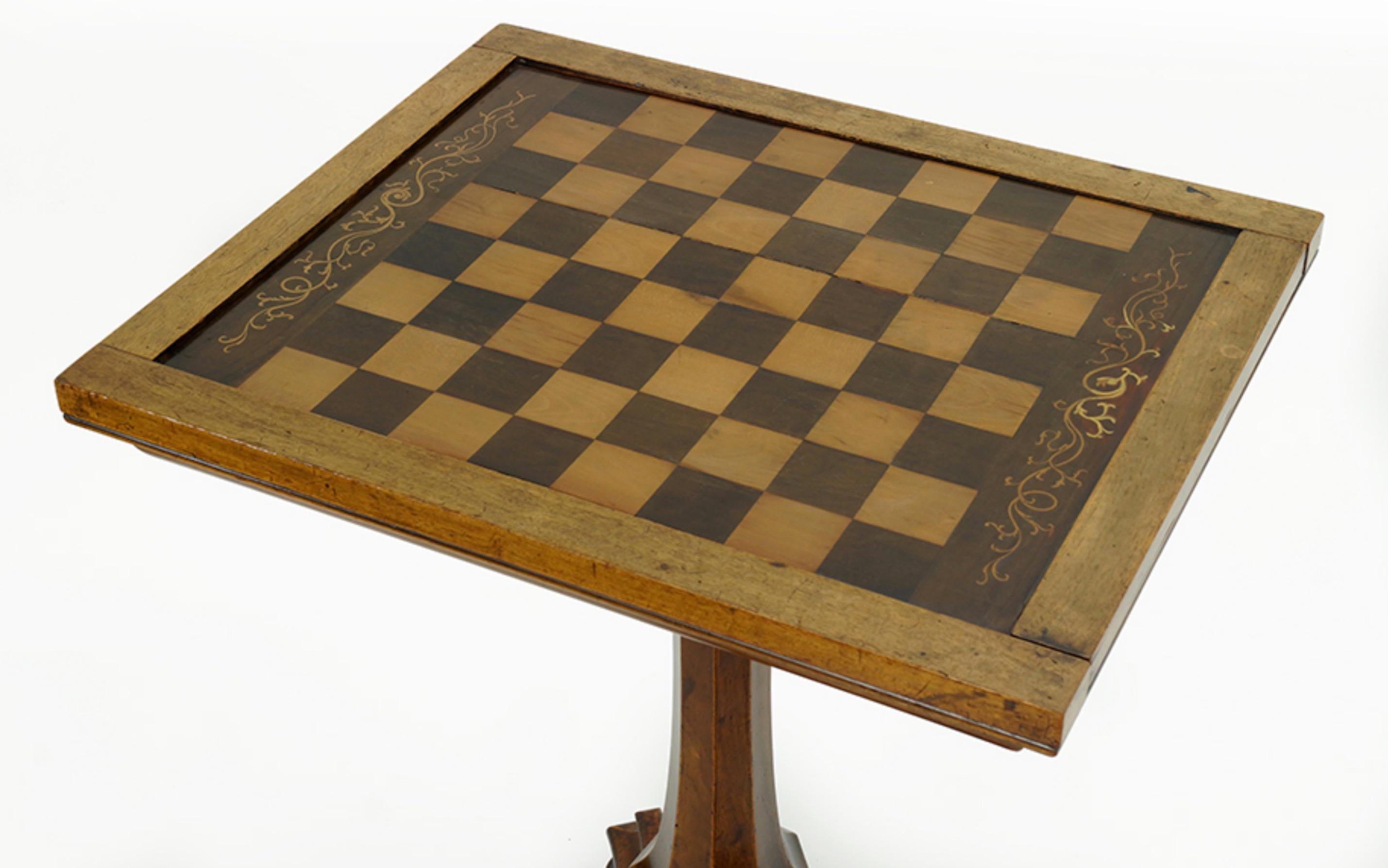 An 19th English walnut games table. 

Table top features a chess / checkerboard on one side and a cribbage and backgammon board on the other, with a storage compartment underneath for game pieces.  We also have other games/small tables, feel free to