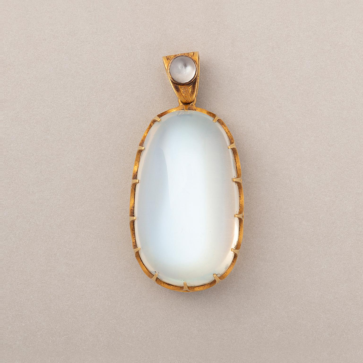 An 18 carat gold pendant set with a large, oval-pear, cabochon cut moonstone open set in fourteen elegant claws, most likely English in origin, circa 1890.

weight: 16.13 grams
dimensions: 40 x 19 mm