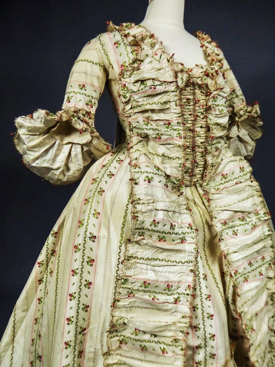 Circa 1780
France

Superb and Complete Taffeta called Mexicaine Sack Back french gown with a mantle coat, pettycoat and stomacher. Sack back pleated mantle dress and double ruffles pagoda sleeves. Very fine brocaded taffeta silk with ombré and