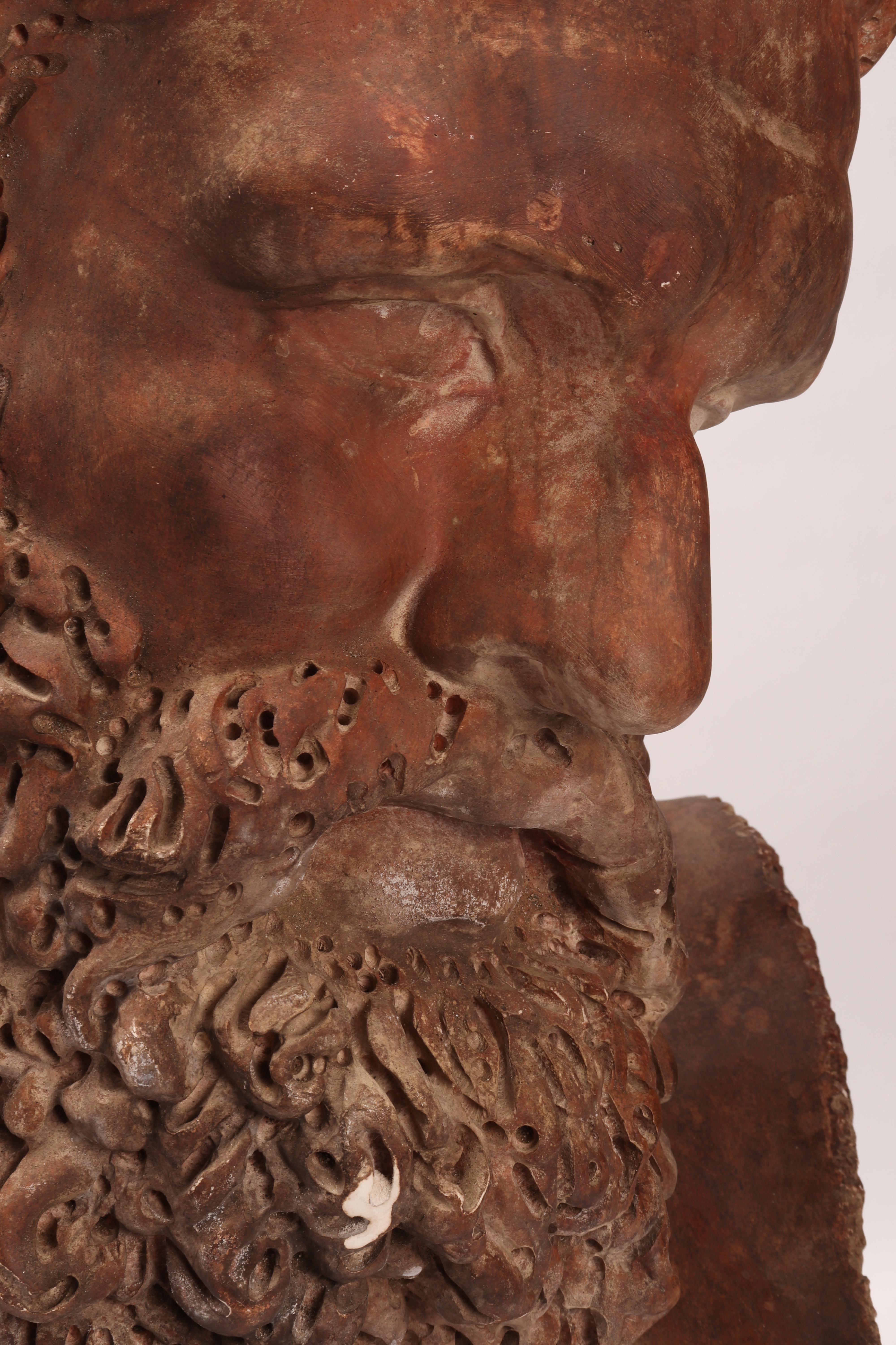 Over the wooden black painted base is set the cast of a big Hercules head. Patina like a terracotta. The cast for drawing teaching in Academy, Italy, circa 1880.