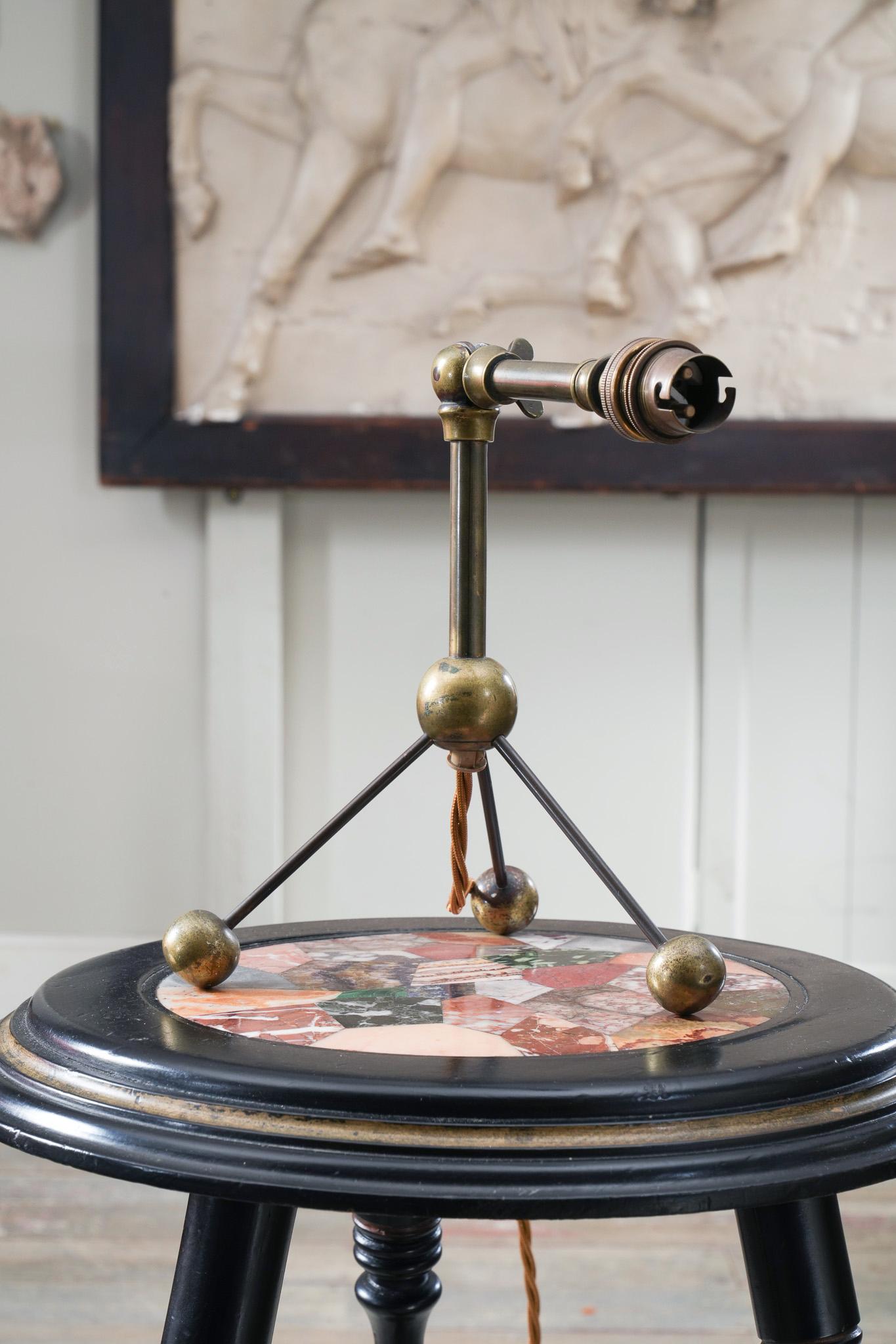 A gilt brass adjustable tripod table light raised on ball feet.

Such an advanced design for the period.