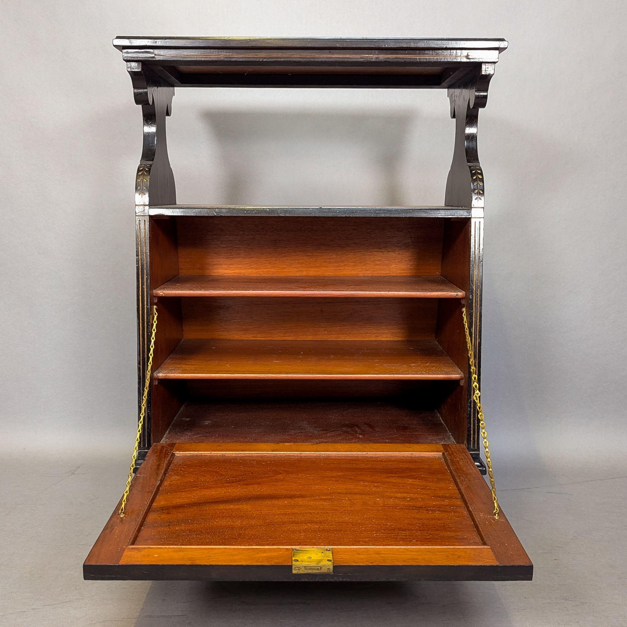 An Aesthetic Movement Amboyna and Ebonized Music Cabinet with gilt decoration In Good Condition For Sale In London, GB